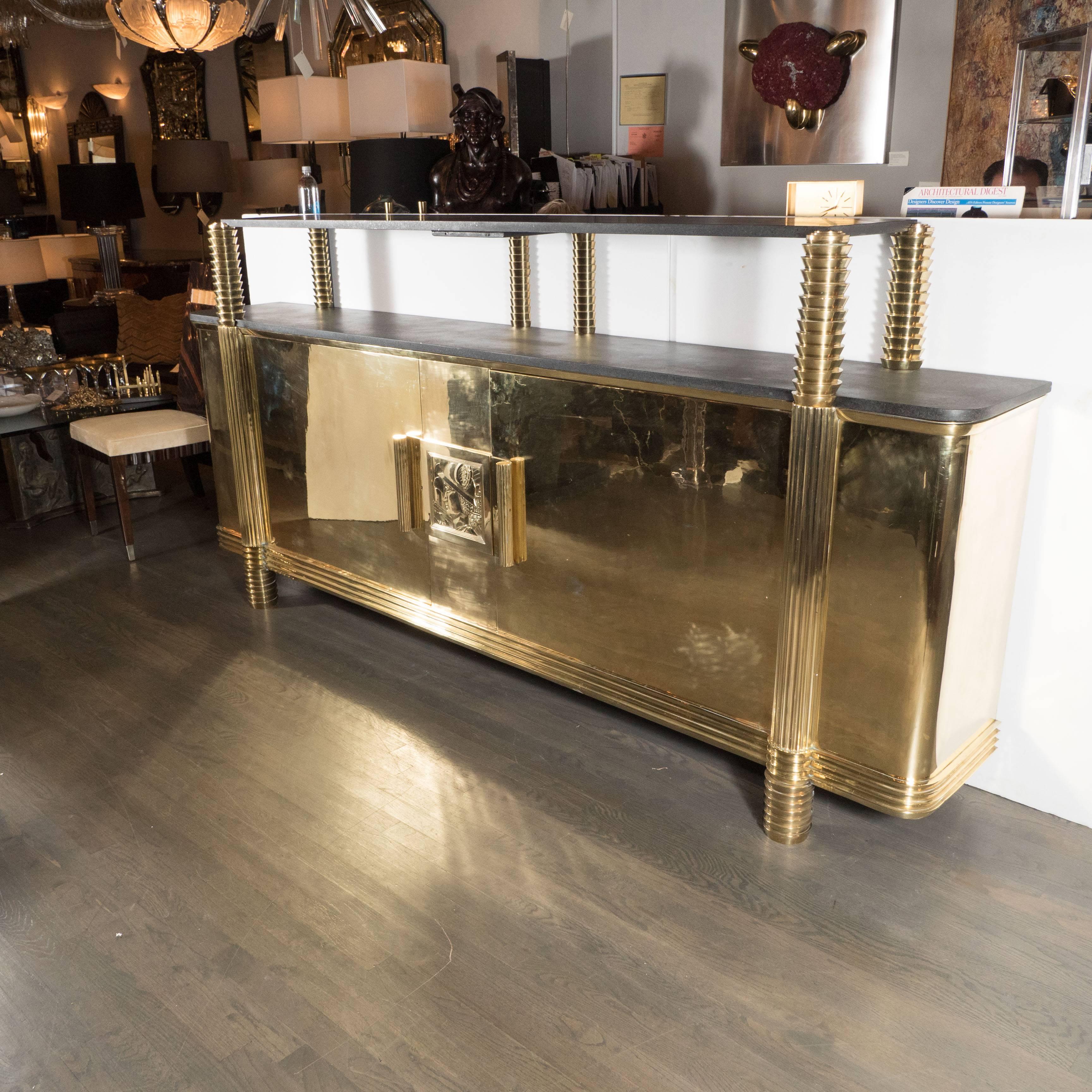 A rare and exquisite French Art Deco sideboard or cabinet in polished brass from the estate of Andy Warhol. Brass feet support a central console featuring a pair of reeded, curve-handled doors. Solid, high-quality construction throughout. A central