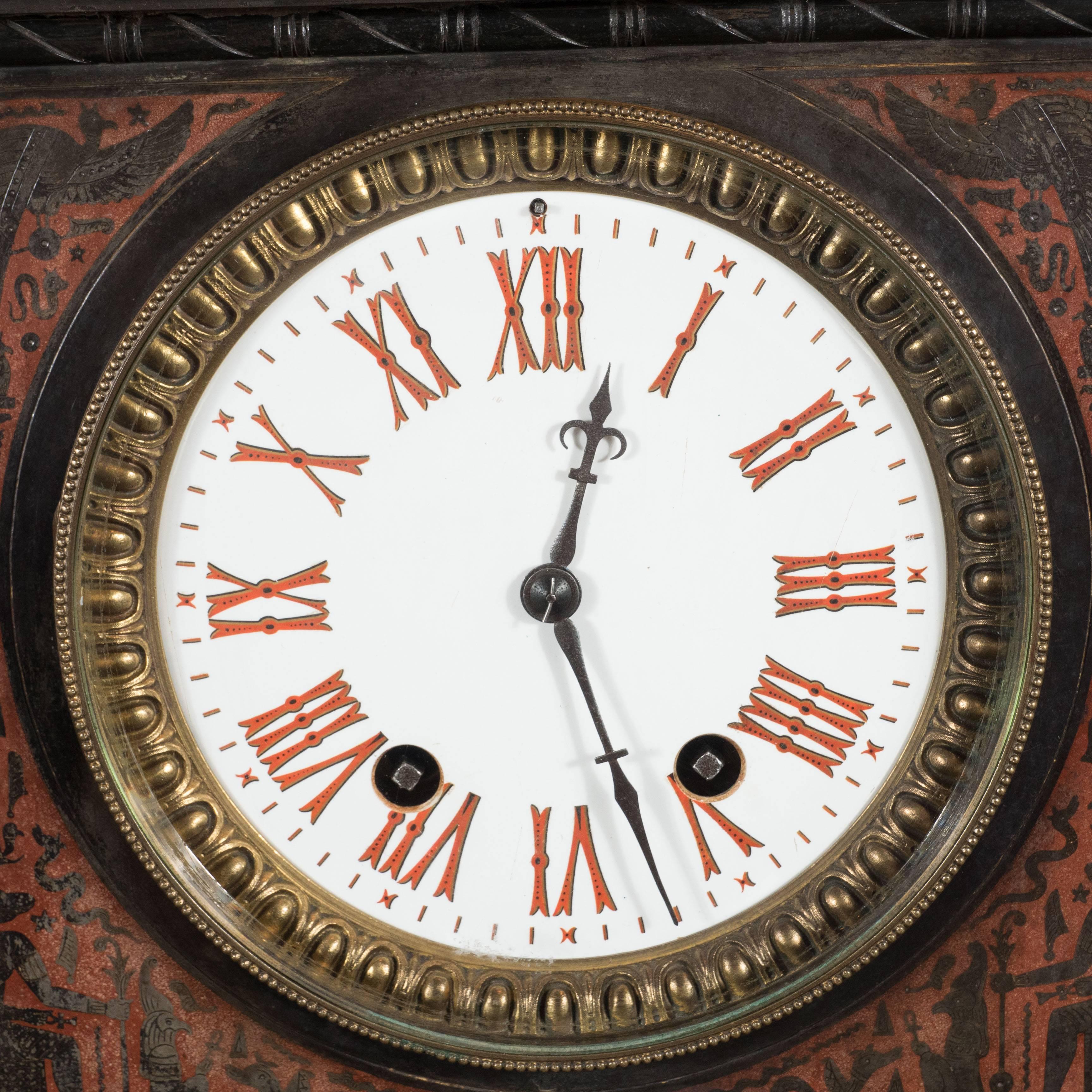 This exceptional mantel clock features a fine quality French bronze-mounted clock in the Assyrian Revival style. It is made of hand-carved black marble with carved and incised hieroglyphics in a rich garnet .This is an outstanding piece with its