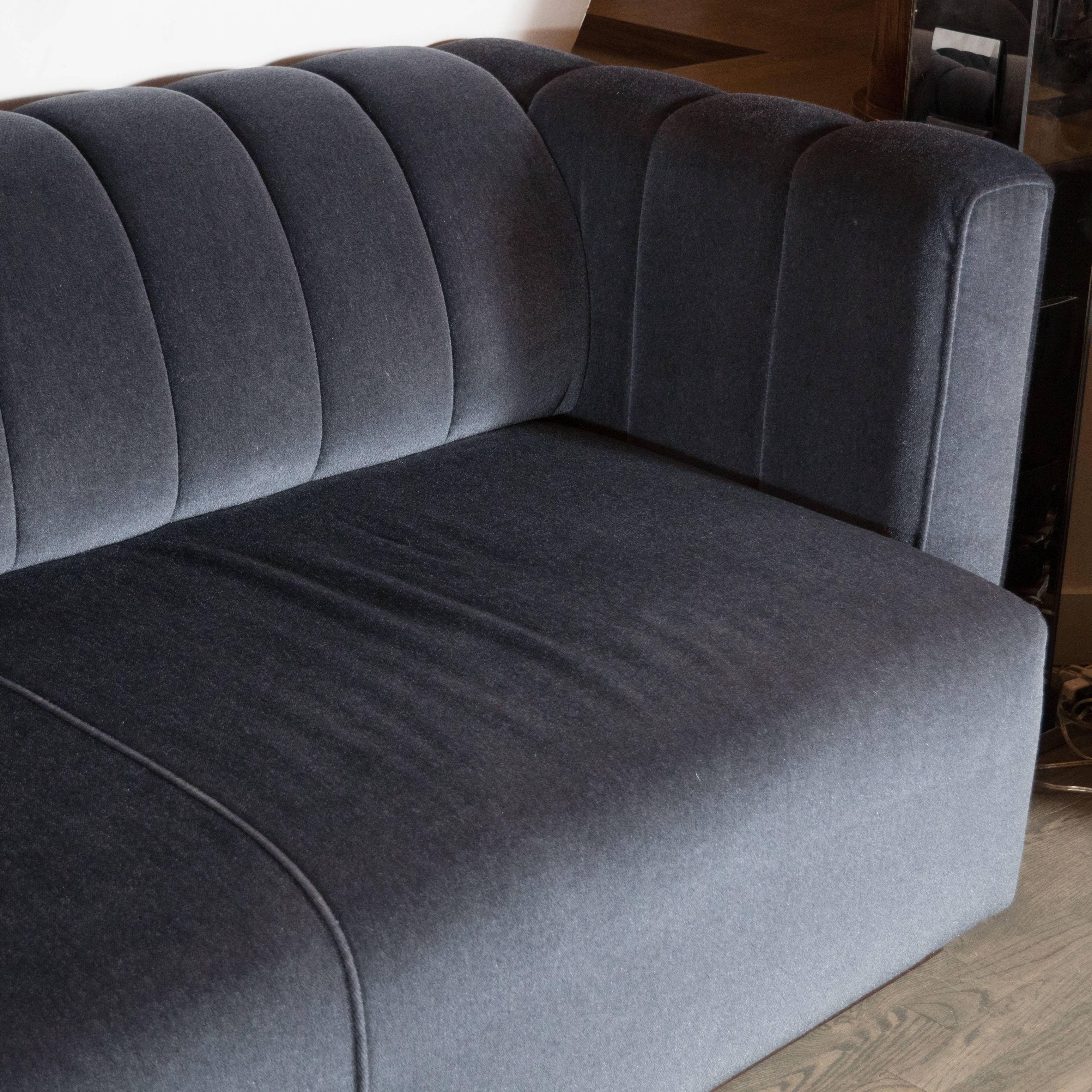 A Mid-Century Modernist sofa by Pace featuring a channel back design and fully upholstered in new gunmetal colored mohair. It has a deep seat and can easily seat five people. The sofa has sleek lines and is also very comfortable. It has been newly