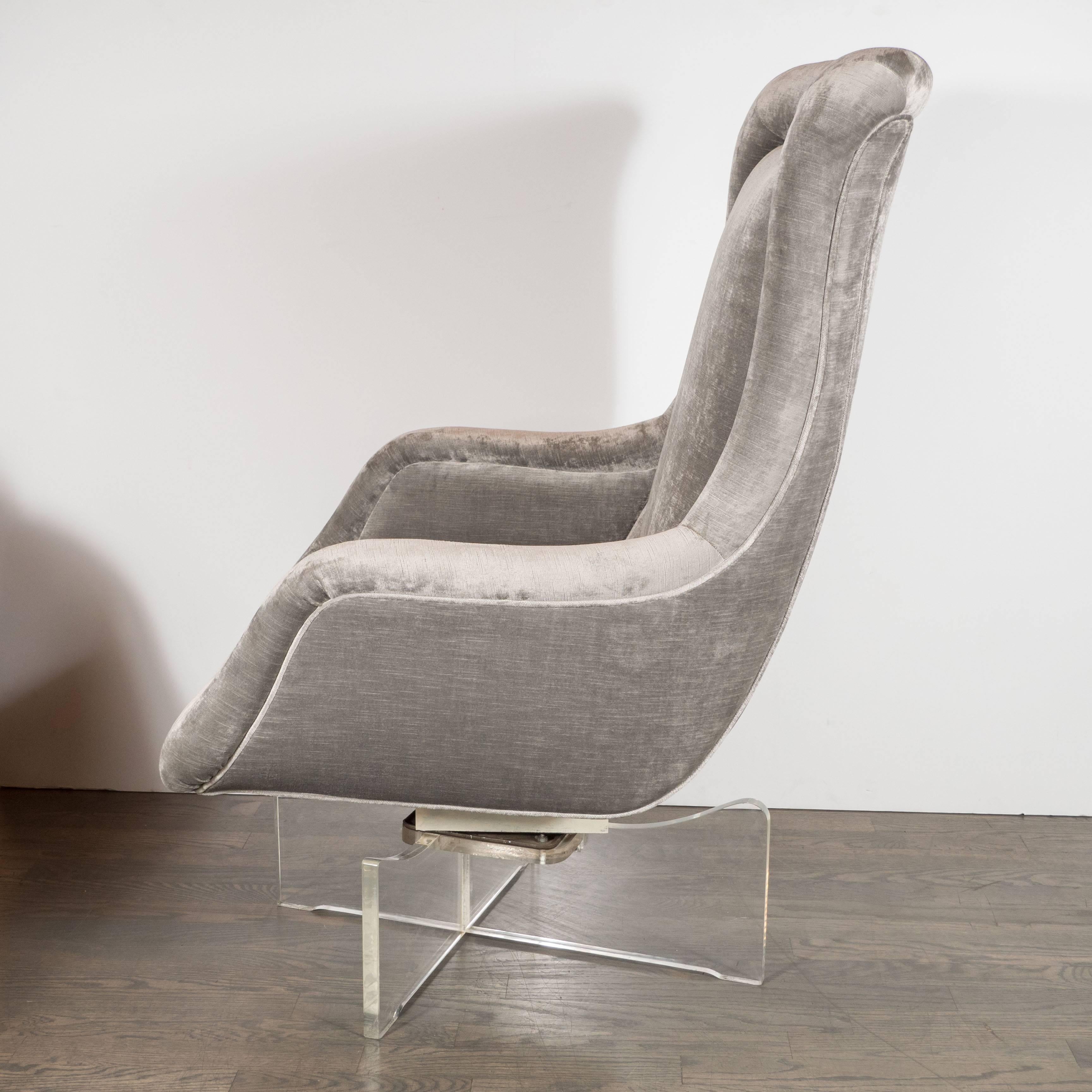 Mid-Century Modernist floating swivel chair on a clear Lucite base in the manner of Vladimir Kagan. A criss-cross Lucite base and swivel mechanism support a fully upholstered high-back chair. Minimal detailing and a curved, 1970s egg-style form with