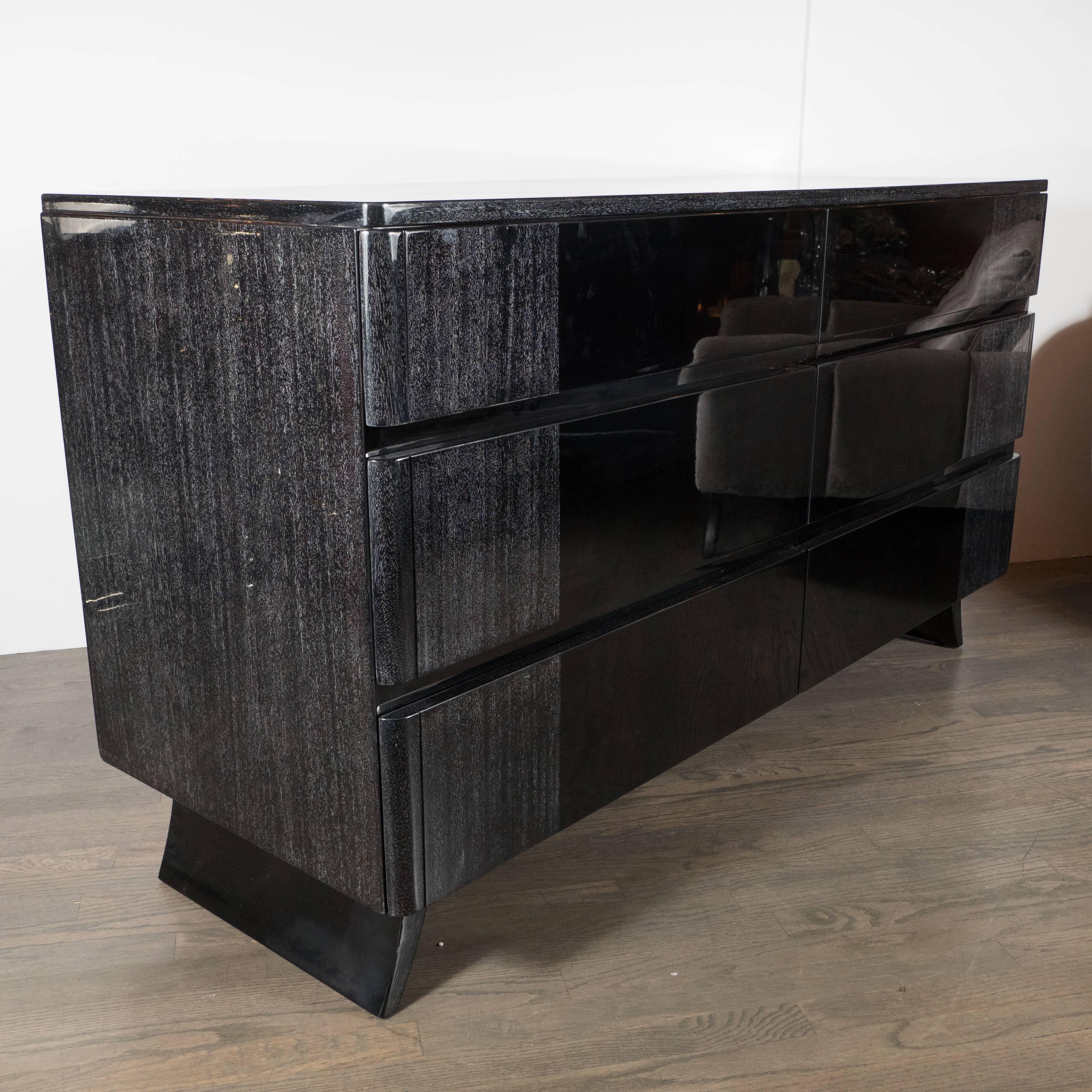 This 1940s low chest by R-Way Furniture Company in silver cerused mahogany and ebonized bird's-eye maple features a streamlined design, rounded edges and splayed legs. It has six drawers providing generous storage. This style lends itself to any