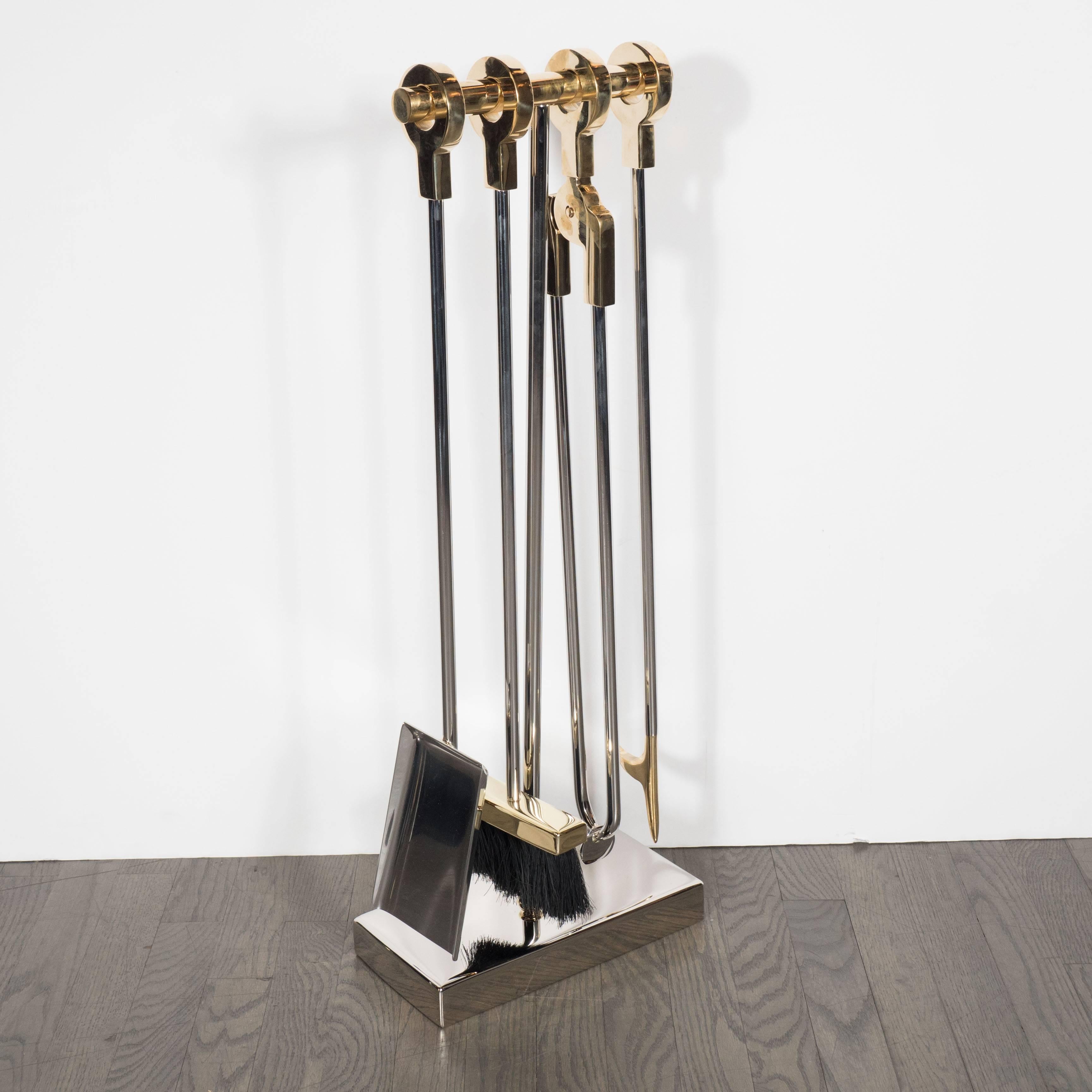 This elegant modernist four-piece fire tool set in polished nickel and polished brass was custom crafted by artisans in New York State exclusively for us. It features rectangular solid polished nickel base and central rod is topped with a polished