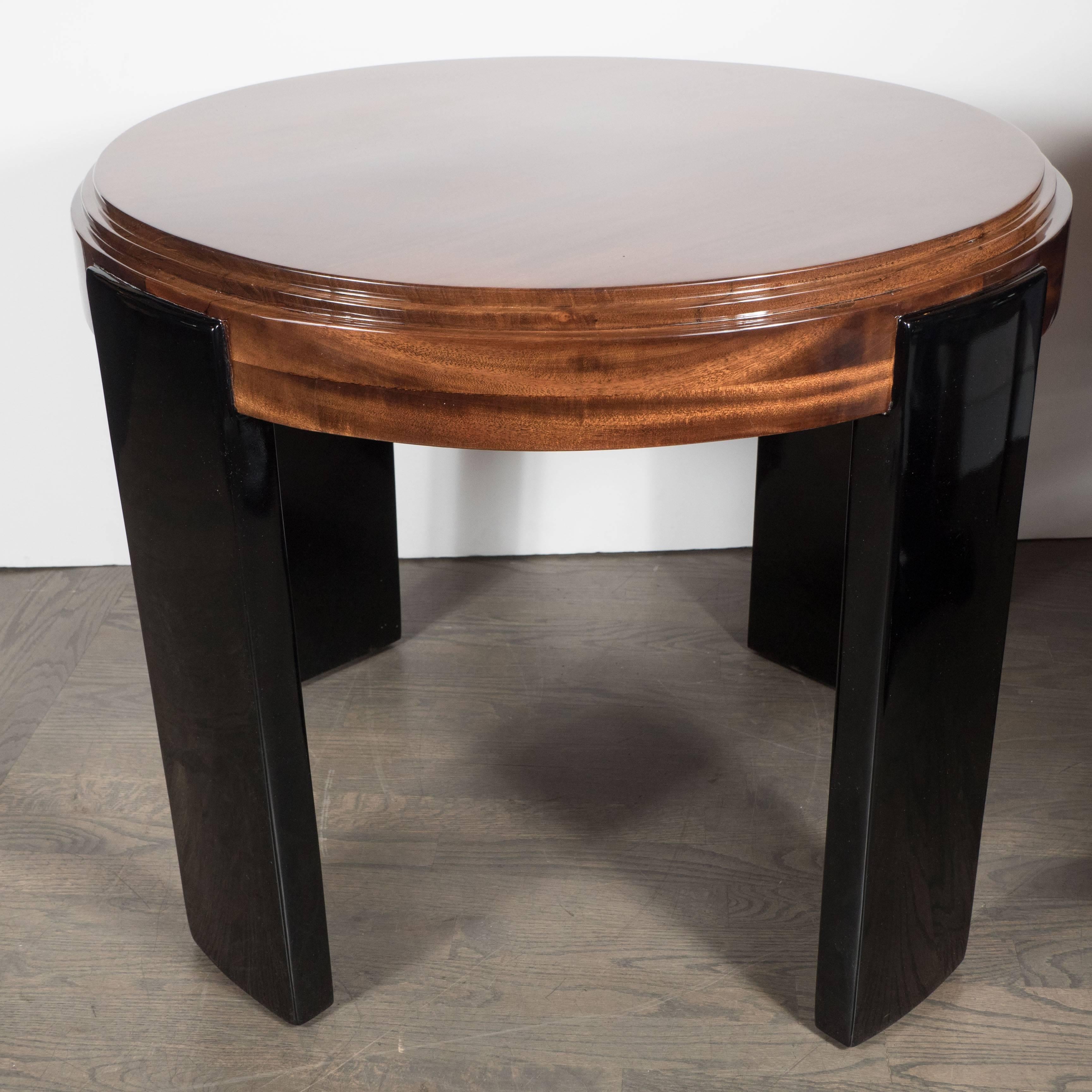 Art Deco skyscraper style stepped detail side table with black lacquer legs, American, circa 1935. This stunning table features a Streamline Art Deco design with a stepped design on the skyscraper style pedestal bases. This table exemplifies the