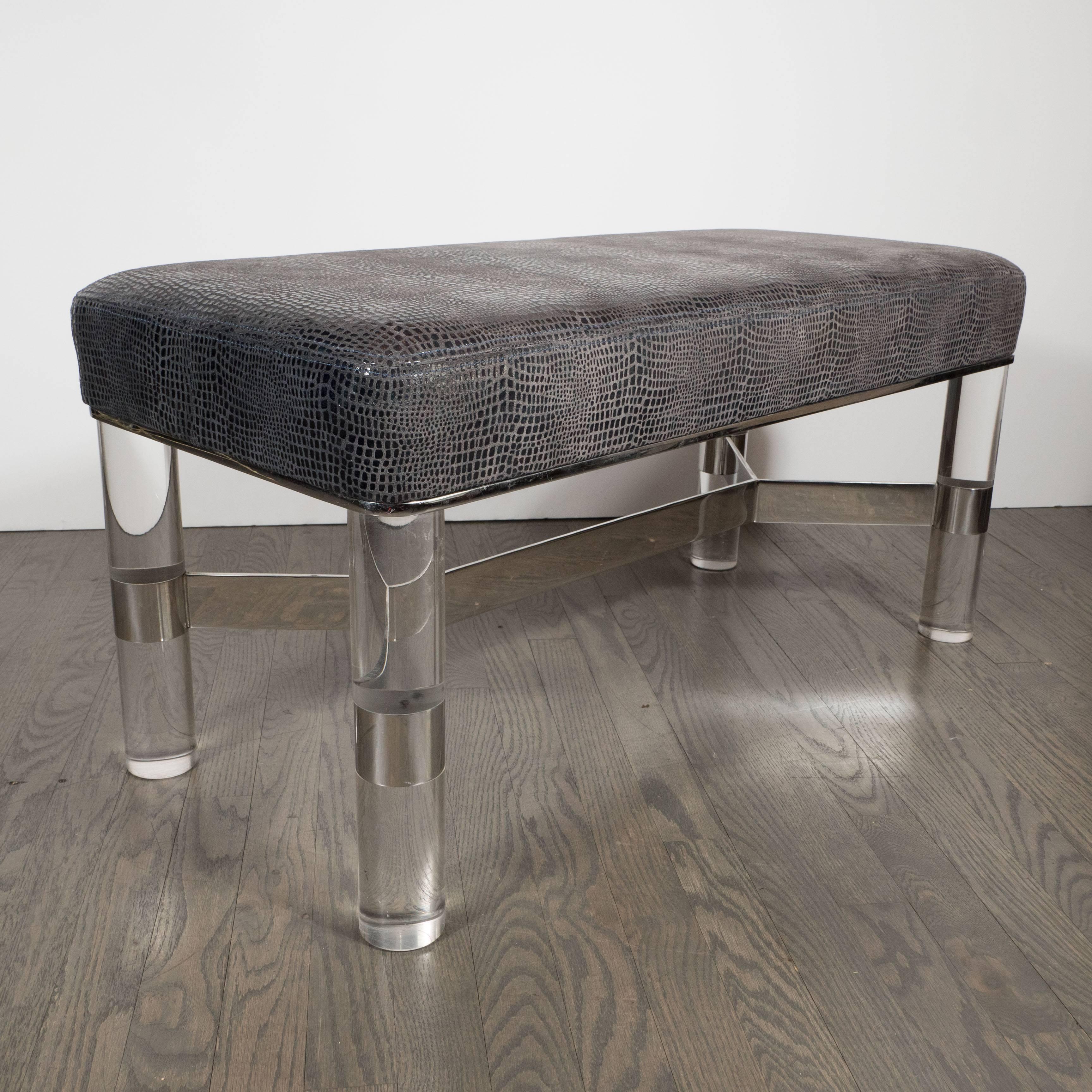 A luxe Mid-Century Modernist Lucite and chrome bench by Karl Springer. 
The seating area with ultra chic crocodile pattern fabric upholstery, the seat cushion is thick and comfortable. The four cylindrical Lucite legs with chrome detailing and