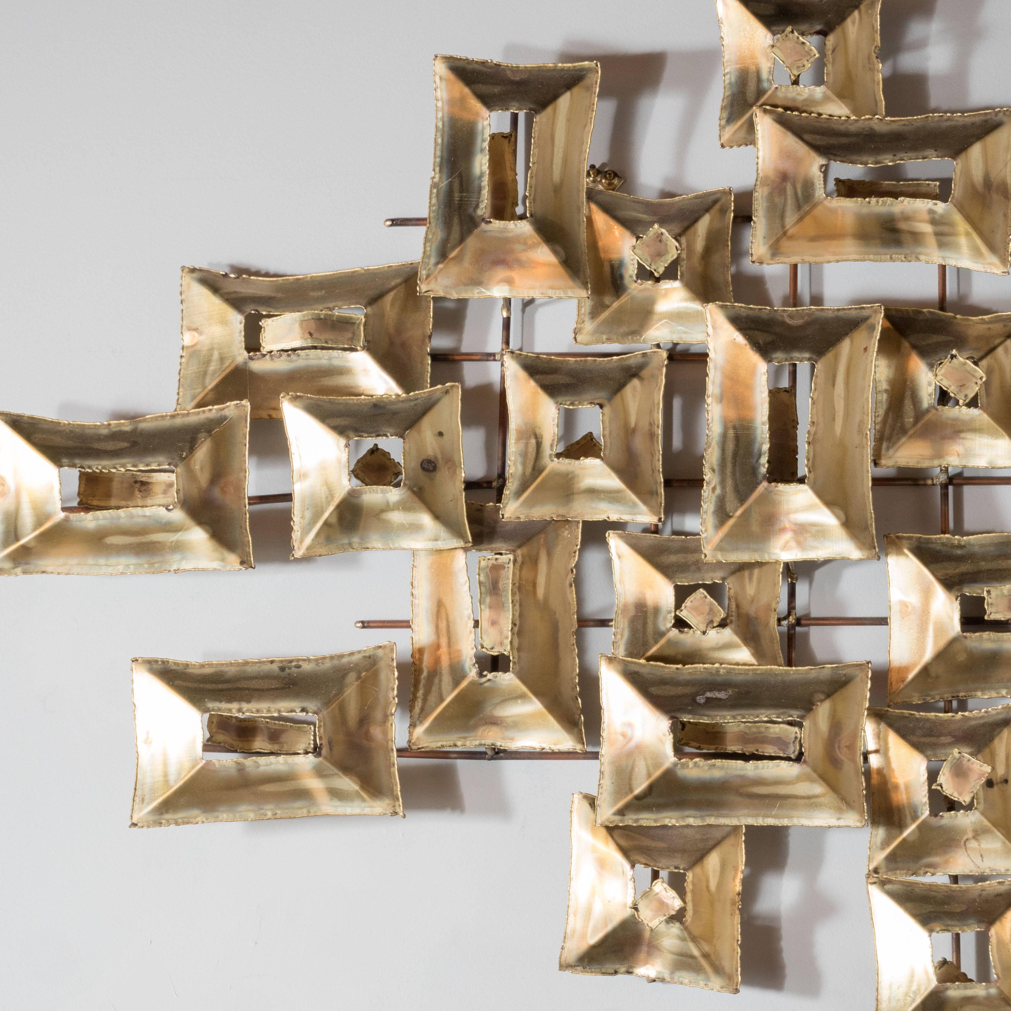 A stunning glistening Brutalist wall sculpture by Curtis Jere with torch cut patined brass attractively mounted in a series of rectangular and square shapes reminiscent of a flight of doves across the sky. Each element is invisibly attached to the