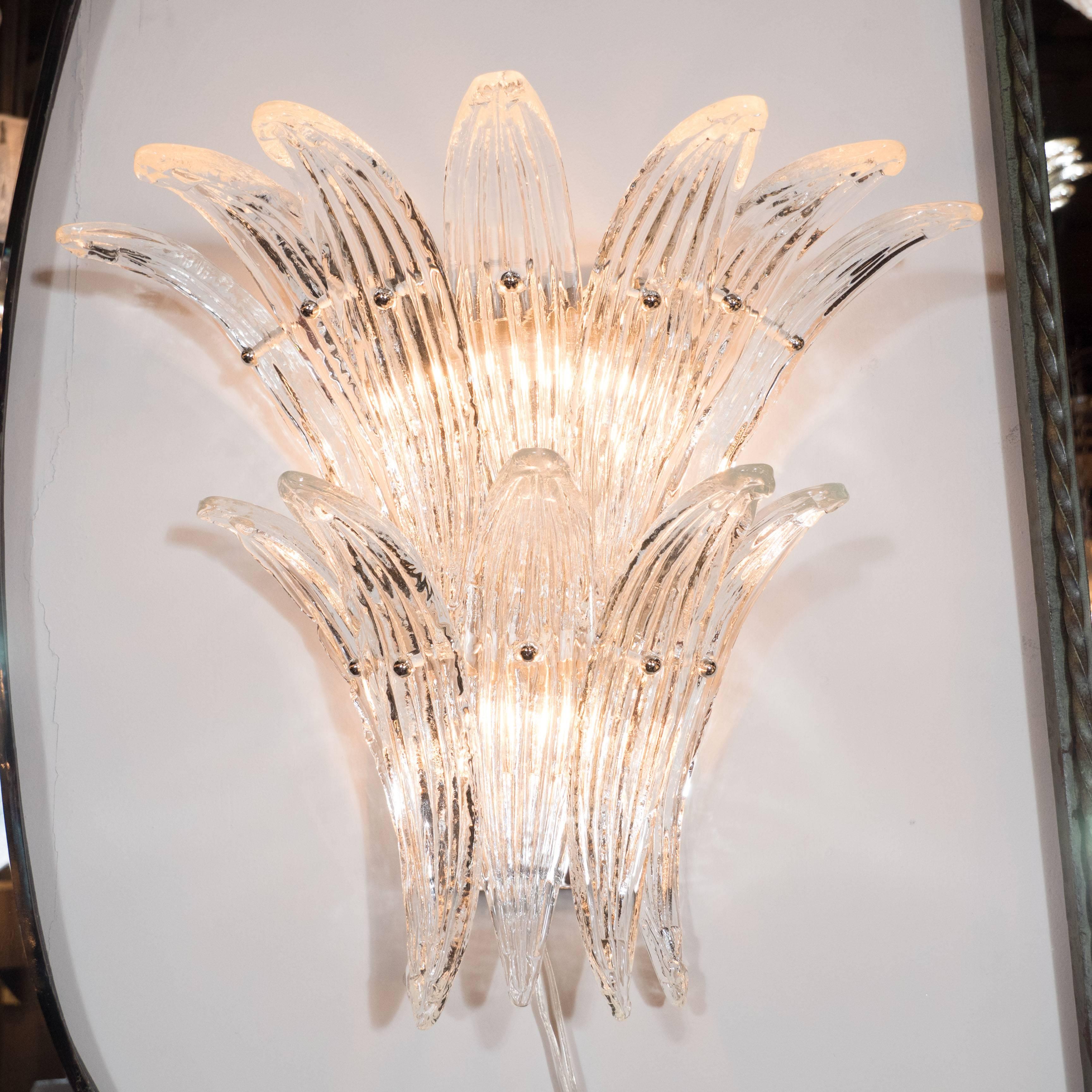 Pair of Mid-Century two-tier palm sconces in clear Murano glass. Each sconce consists of a chrome frame with 12 individually attached handblown Murano glass palm fronds. Chrome ball supports screw into rods holding up each from at its centre. Each