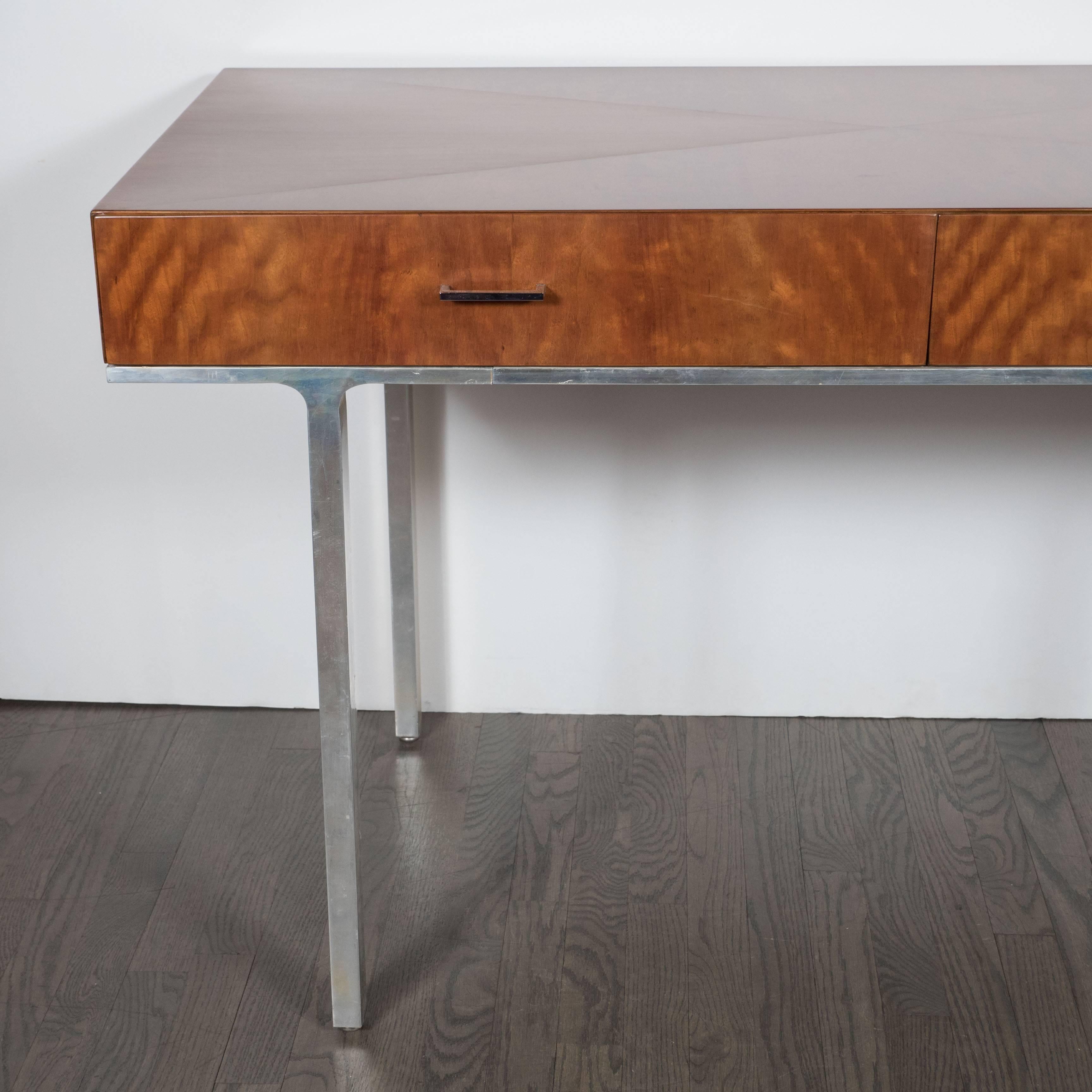 A stunning Mid-Century Modern desk in polished aluminum and bookmatched walnut, the tabletop is decorated with beautiful geometric triangular patterns, the grain of the bookmatched walnut is well defined, the two drawers are attrively finsihed with