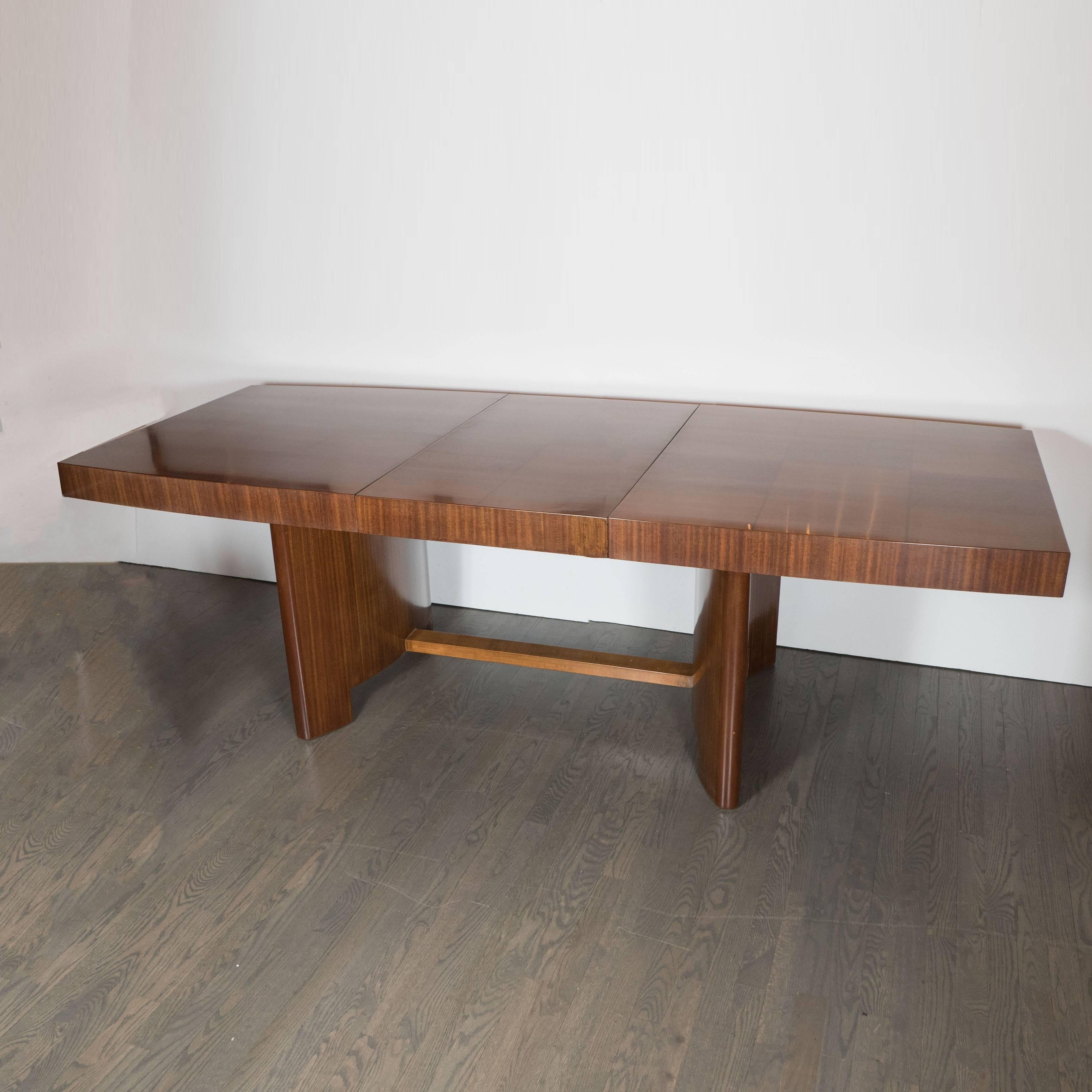 An elegant Art Deco dining table by Gilbert Rohde for Herman Miller (#3725) in Maidou burl and mahogany. 
A stunning tabletop in Maidou burl and mahogany delicately decorated with an attractive pattern of squares inset with thin lines criss