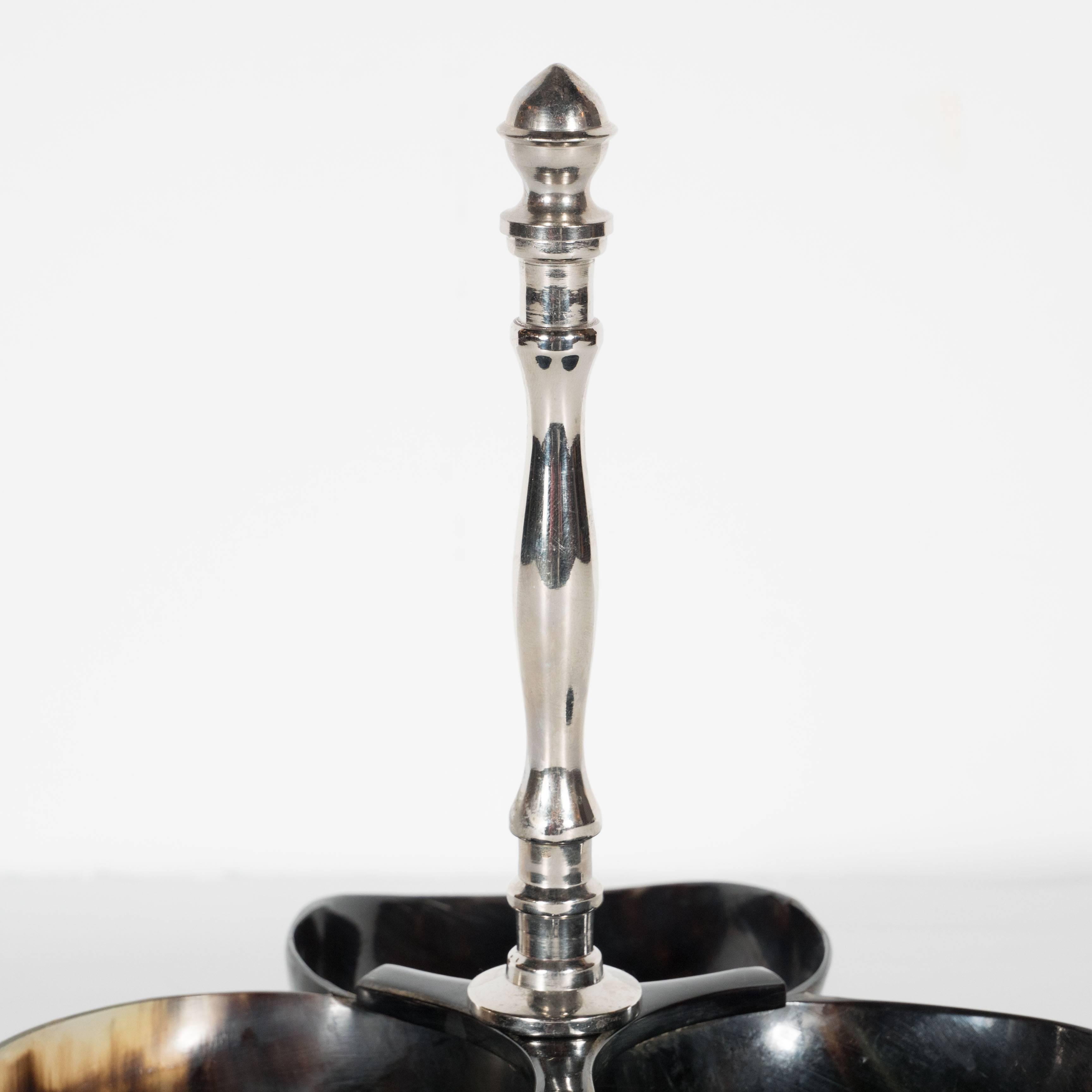 A modernist nut or candy Horn dish or bowl set with detailed chrome handle. From a trio of connected Horn bowls stems a detailed polished chrome handle. A great piece to display a selection of nuts, dry fruit or candy. This piece is in excellent