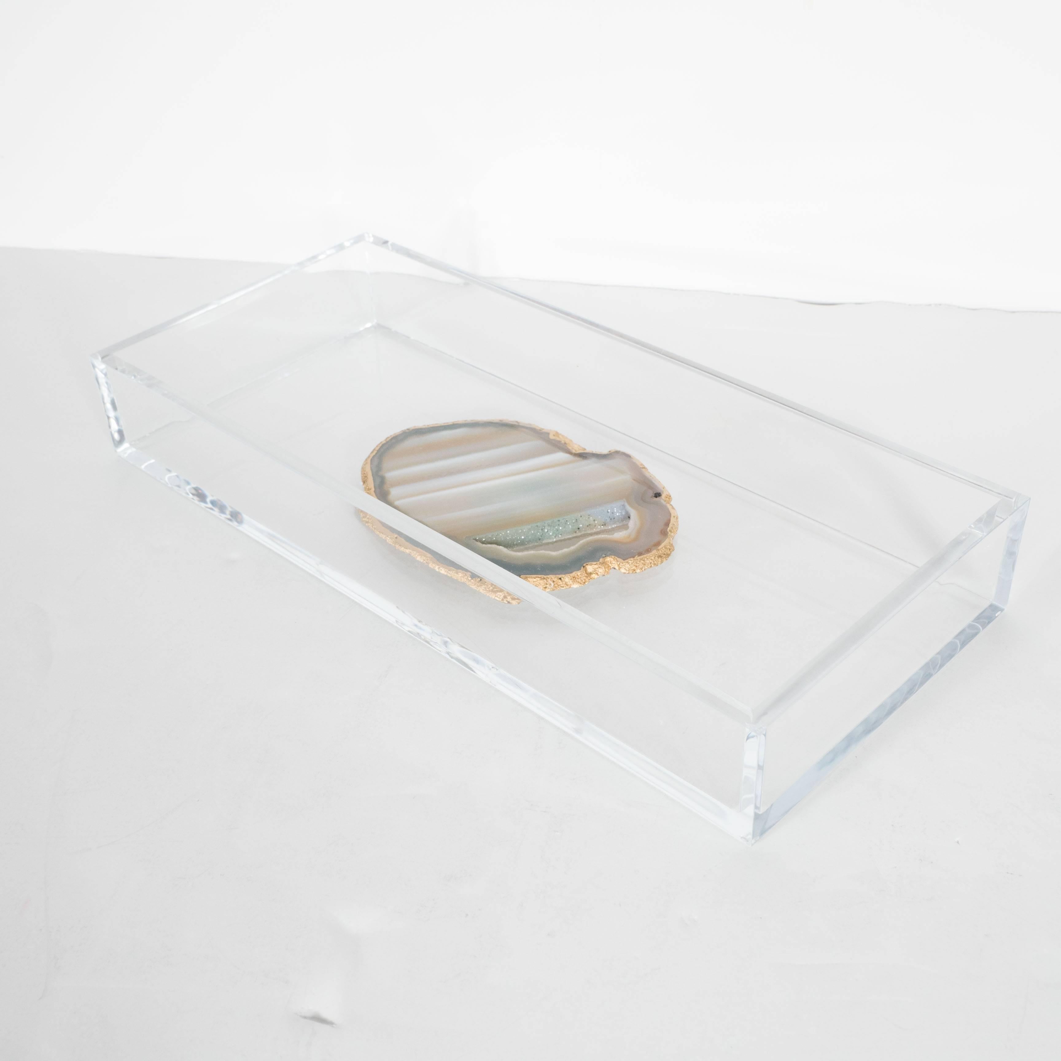 This modernist rectangular tray is in Lucite with a central sliced agate insides of grey and natural hues. A great desk tray or catch all,
American,
20th century.