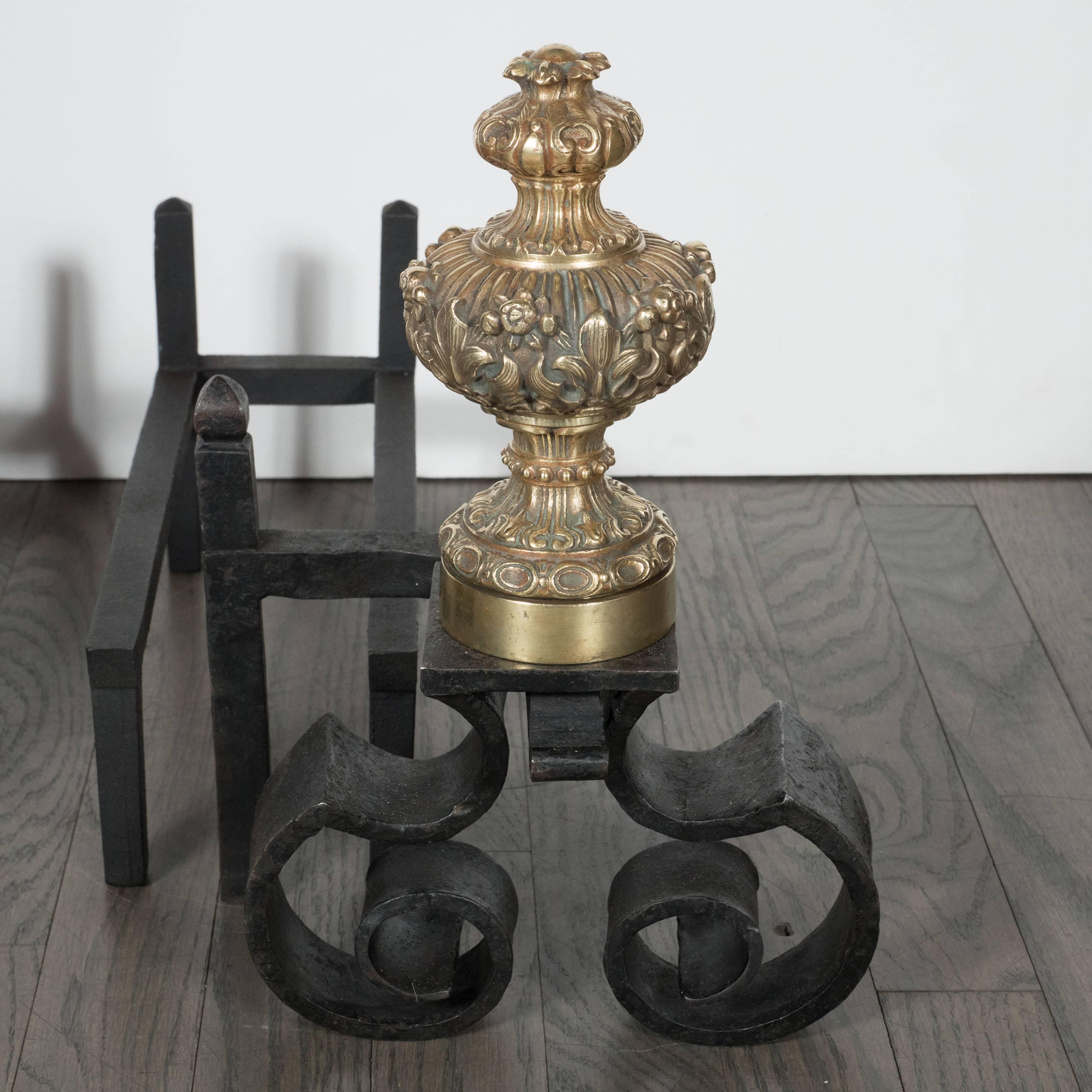 This elegant neoclassical Baroque andirons feature a hand-forged scroll design base in handwrought iron with solid brass finials featuring baroque patterns as well as a stylized acanthus motif. Marked made in France on the underside. With their