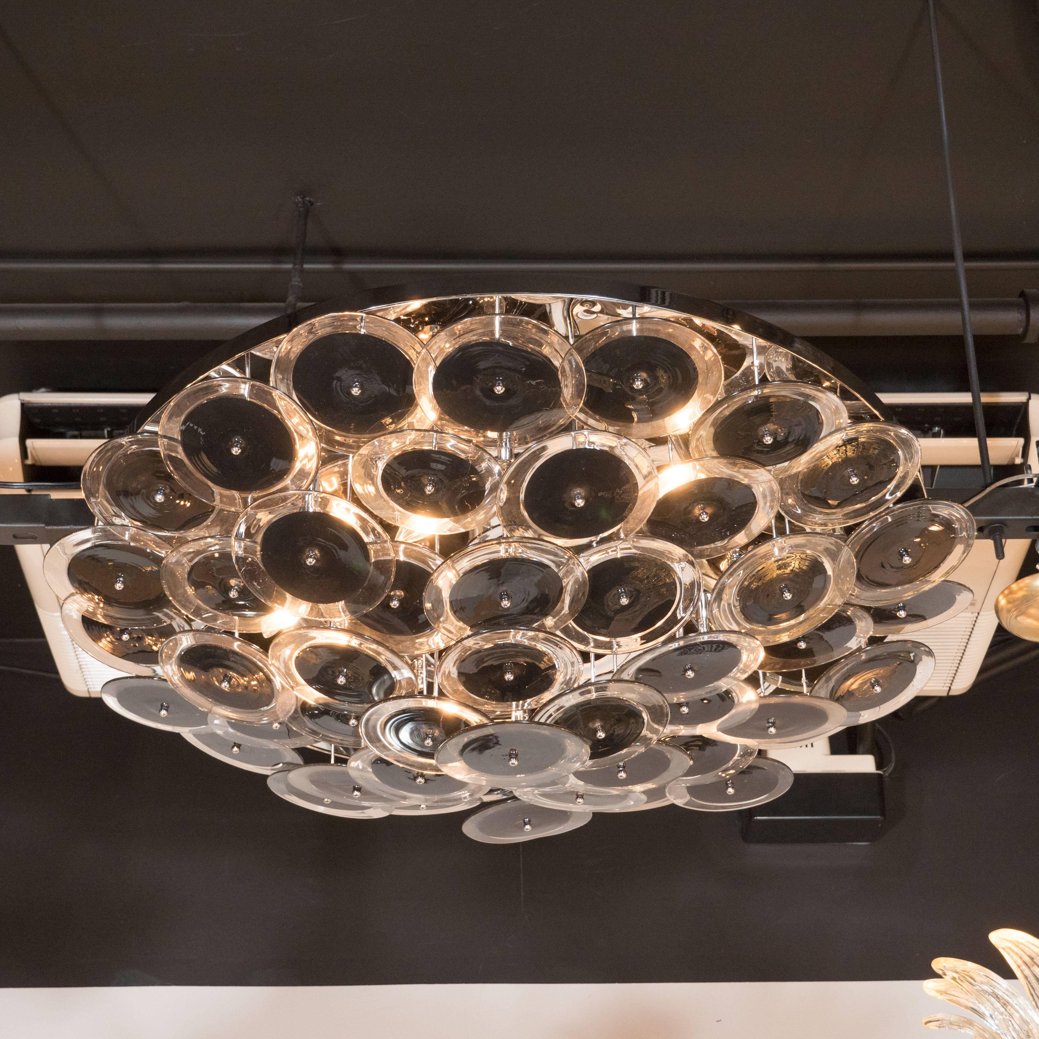 Stunning Vistosi flush mount chandelier with handblown Murano black and clear glass discs. This flush mount chandelier consists of an array of numerous handblown Murano clear glass discs that each incorporate a central opaque texture that is