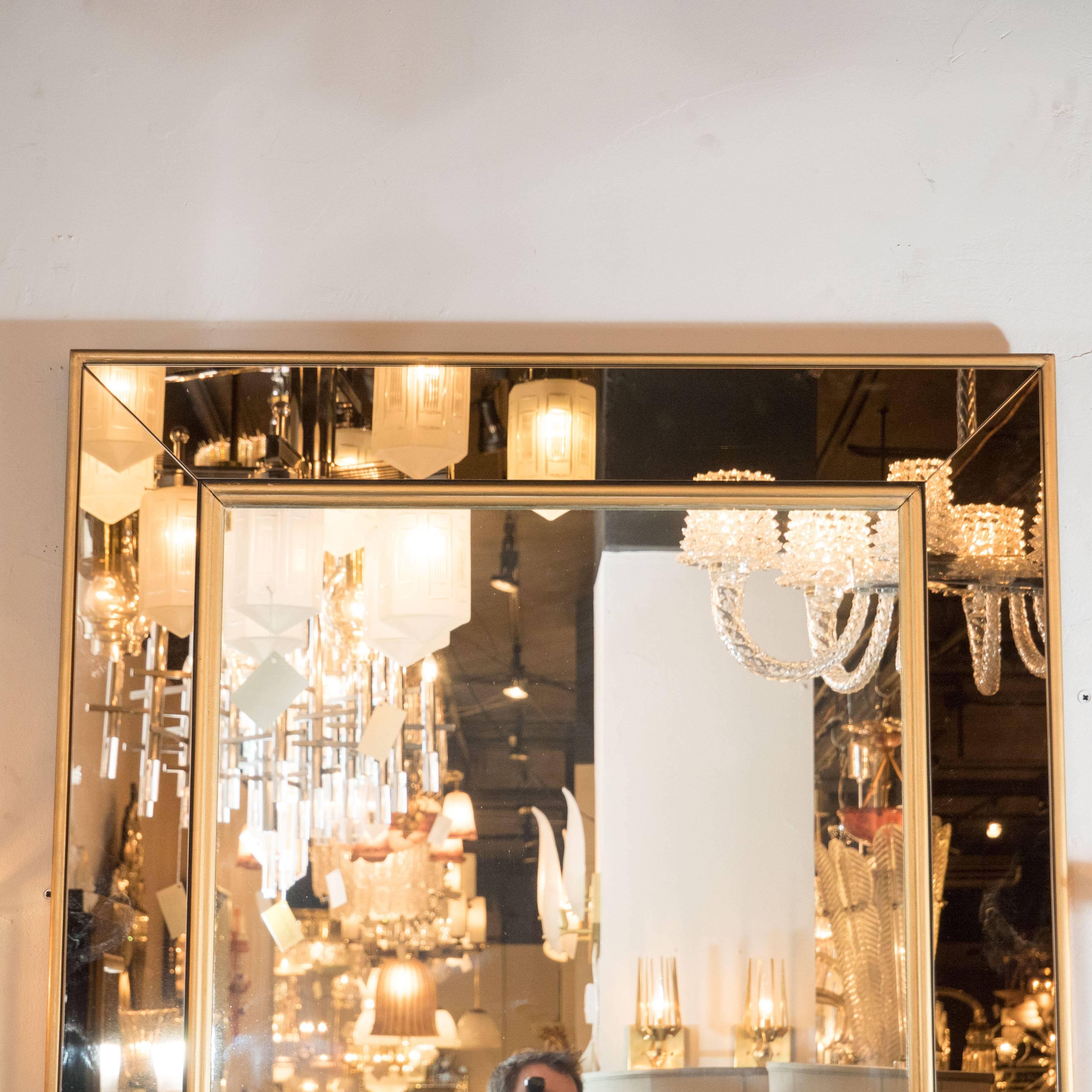 A stunning Mid-Century Modern giltwood and bronze mirrored glass mirror, the rectangular shaped stylish mirror with inset four panels of bronze mirror and giltwood frame. A modern yet classical elegant design fits any style of interior, perfect for