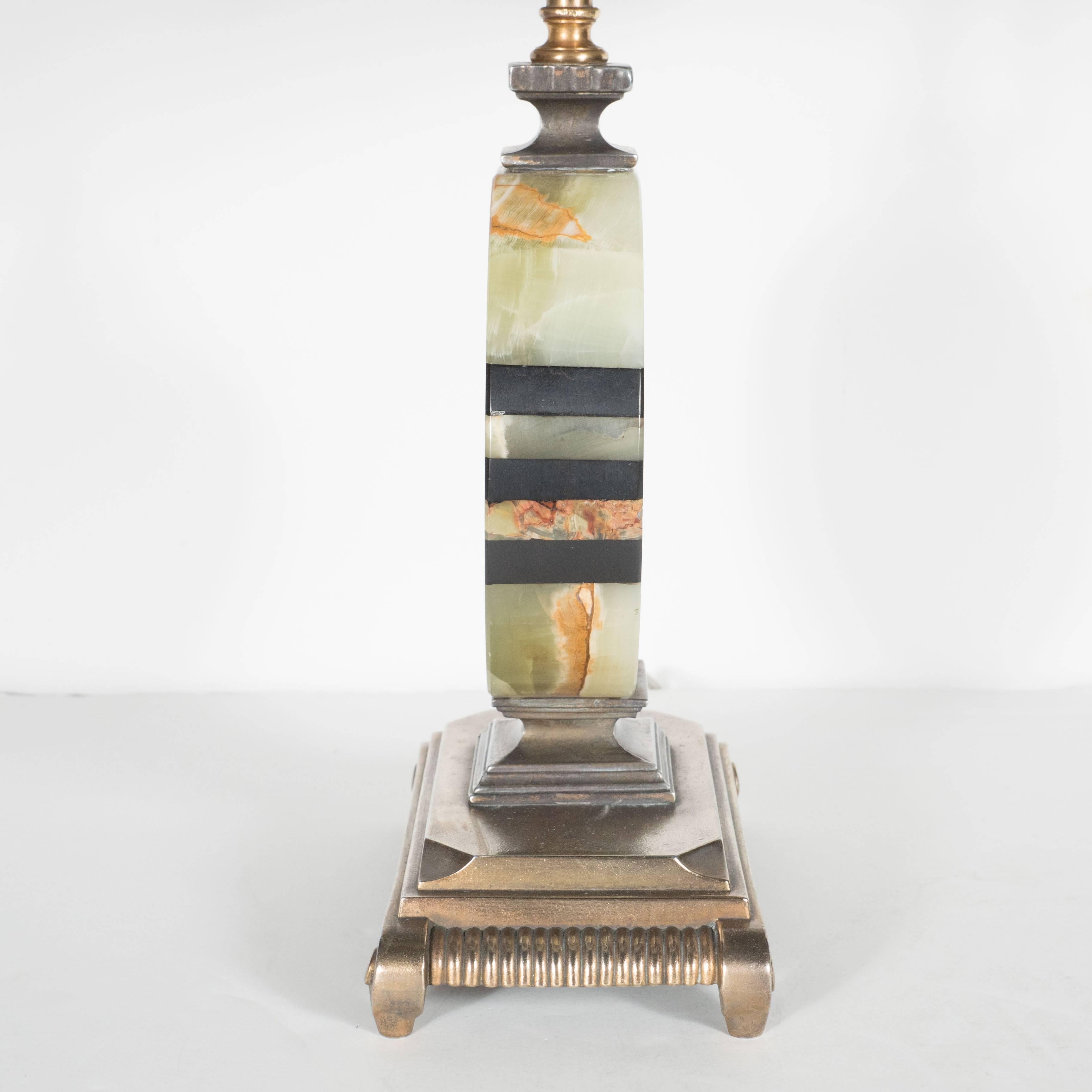 Gorgeous Art Deco Skyscraper table lamp in exotic green onyx and gilded bronze
superbly designed in the Art Deco style with Skyscraper base in gilded bronze upon which stands a flask shape body in onyx in various shades of green attractively inlaid
