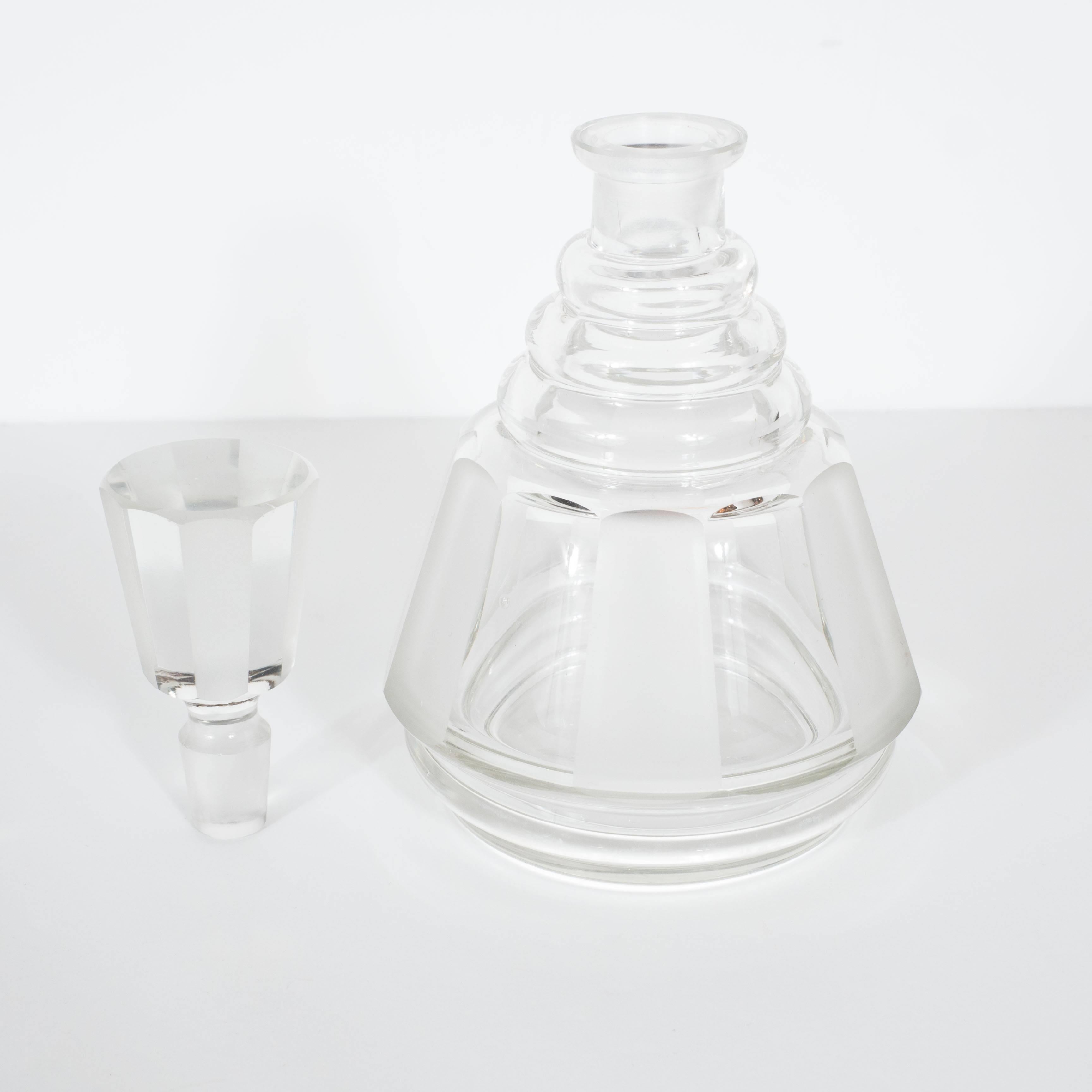 This Cubist style Art Deco glass decanter features frosted accents with a bee hive design that receives the cylindrical stopper. A wonderful addition to a bar or for the Art Deco collector. A great example of the Art Deco movement in