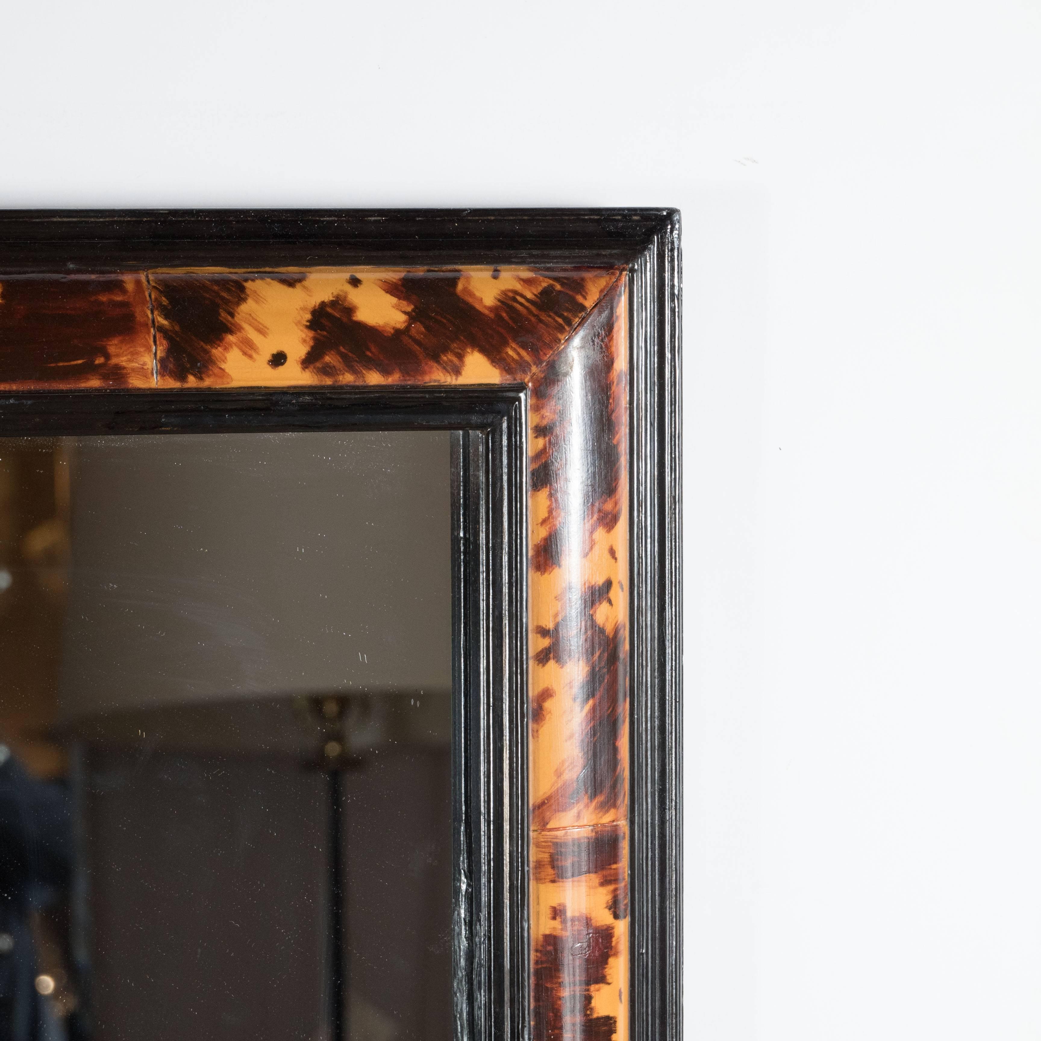 Ultra chic Mid-Century Modernist mirror in faux tortoise and black lacquer, American, circa 1970, the exquisite mirror frame with an exotic trompe l'oeil tortoise effect typical for the interiors of the 1970s, the frame in a beautiful stepped design