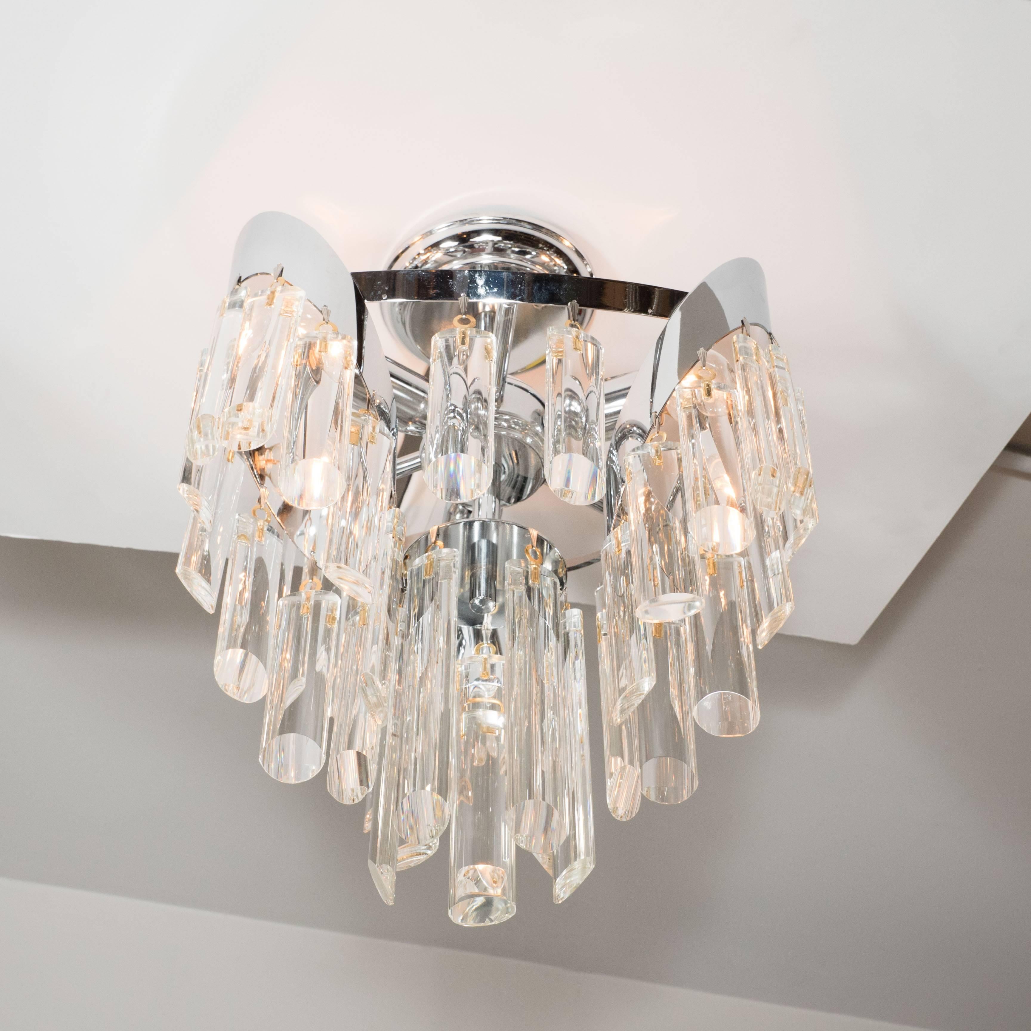 This elegant Mid-Century Modern chandelier was realized by the storied Austrian lighting atelier Lobmeyr, circa 1979. It features an abundance of bias cut crystal rods suspended from a nickel frame. This chandelier infuses a classical sensibility