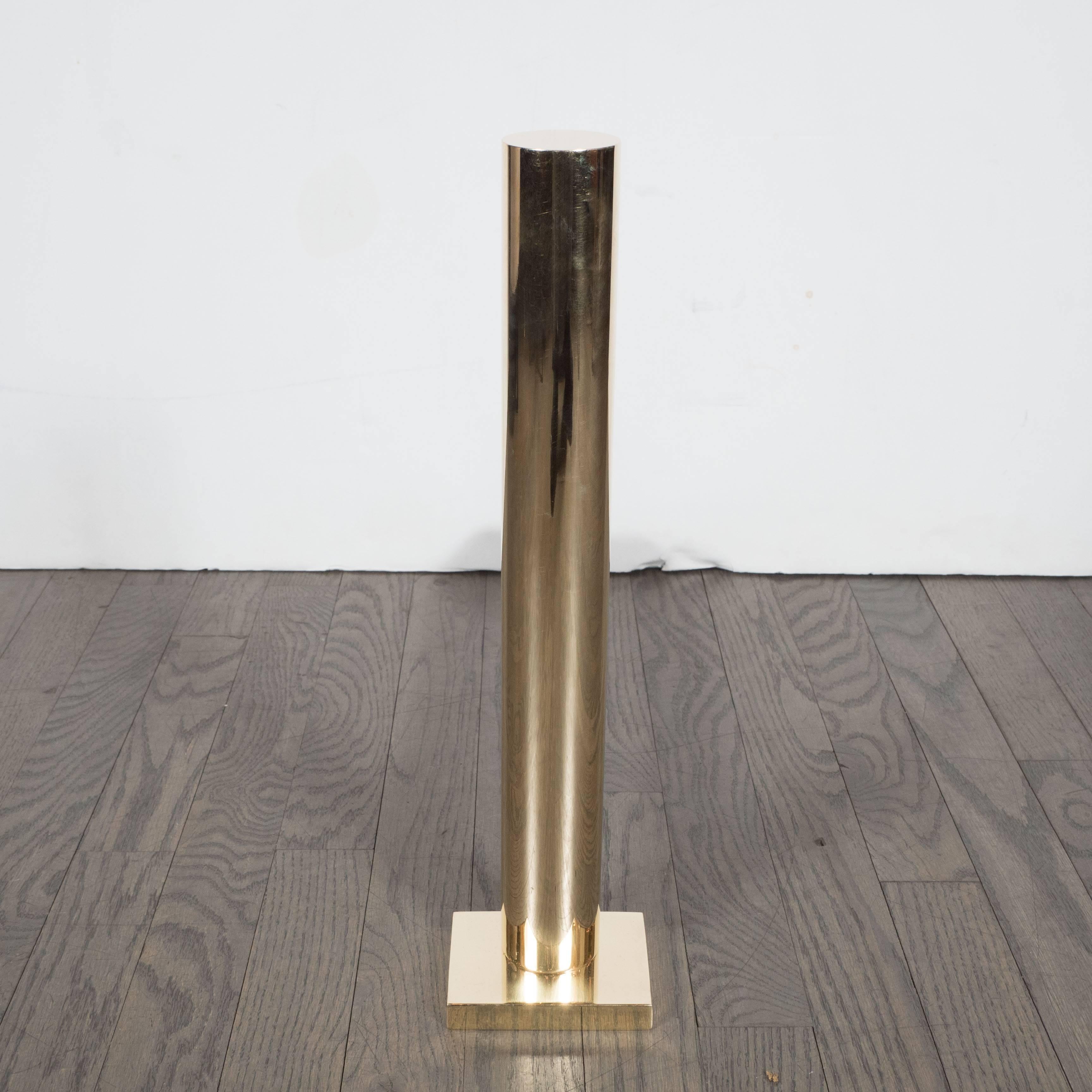 These stunning custom andirons feature a polished brass cylindrical form, rectangular base and black enamel supports. Please ask about the very many available finish options. These can be beautifully accompanied by our custom range of fire tools and