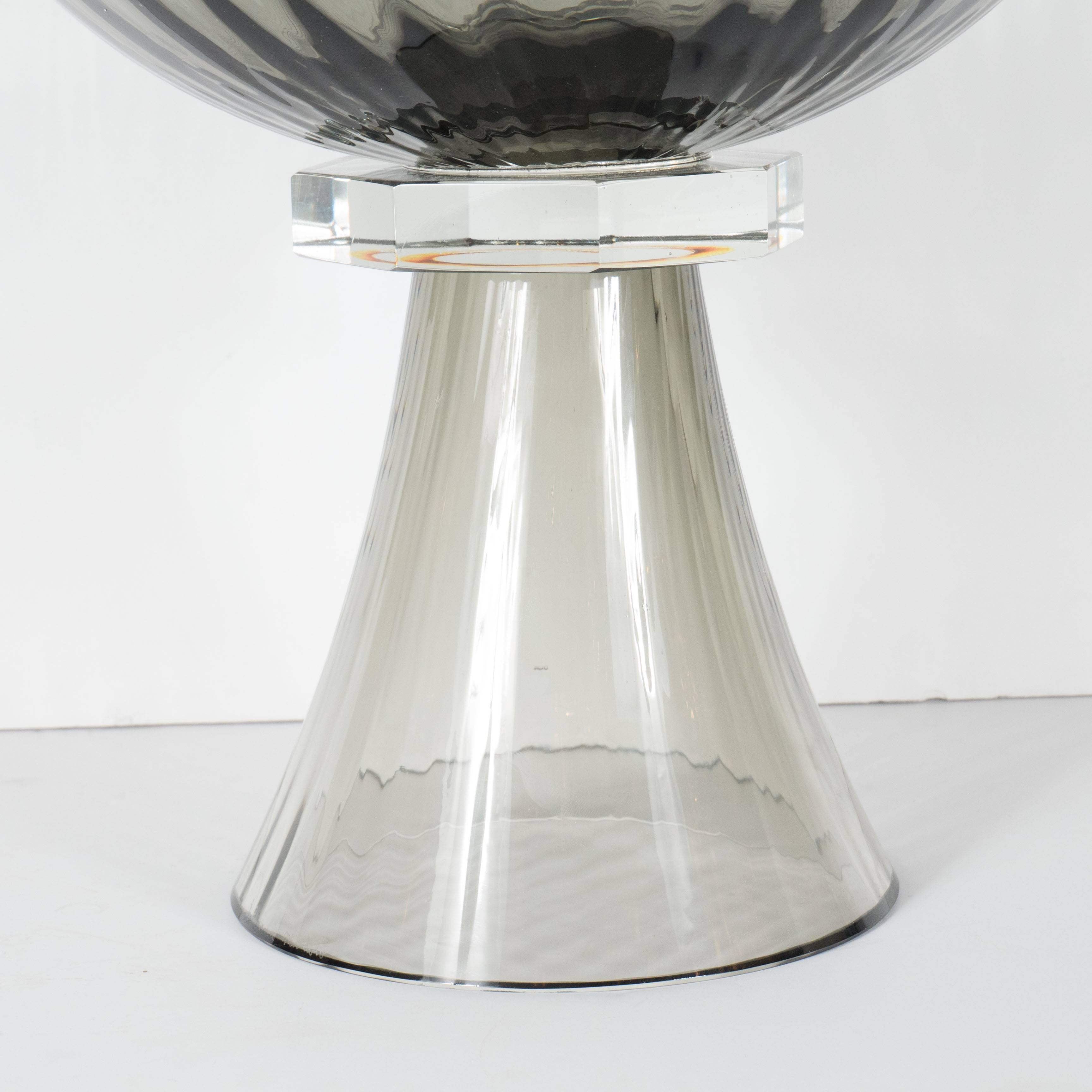 This handblown Murano glass bowl or vase features fluted footing with a tapered neck design in smoked glass. An elegant, clear octagonal glass collar supports a smoked glass bowl with fluted detail. Custom order, 6 week delivery.

Italian, 21st