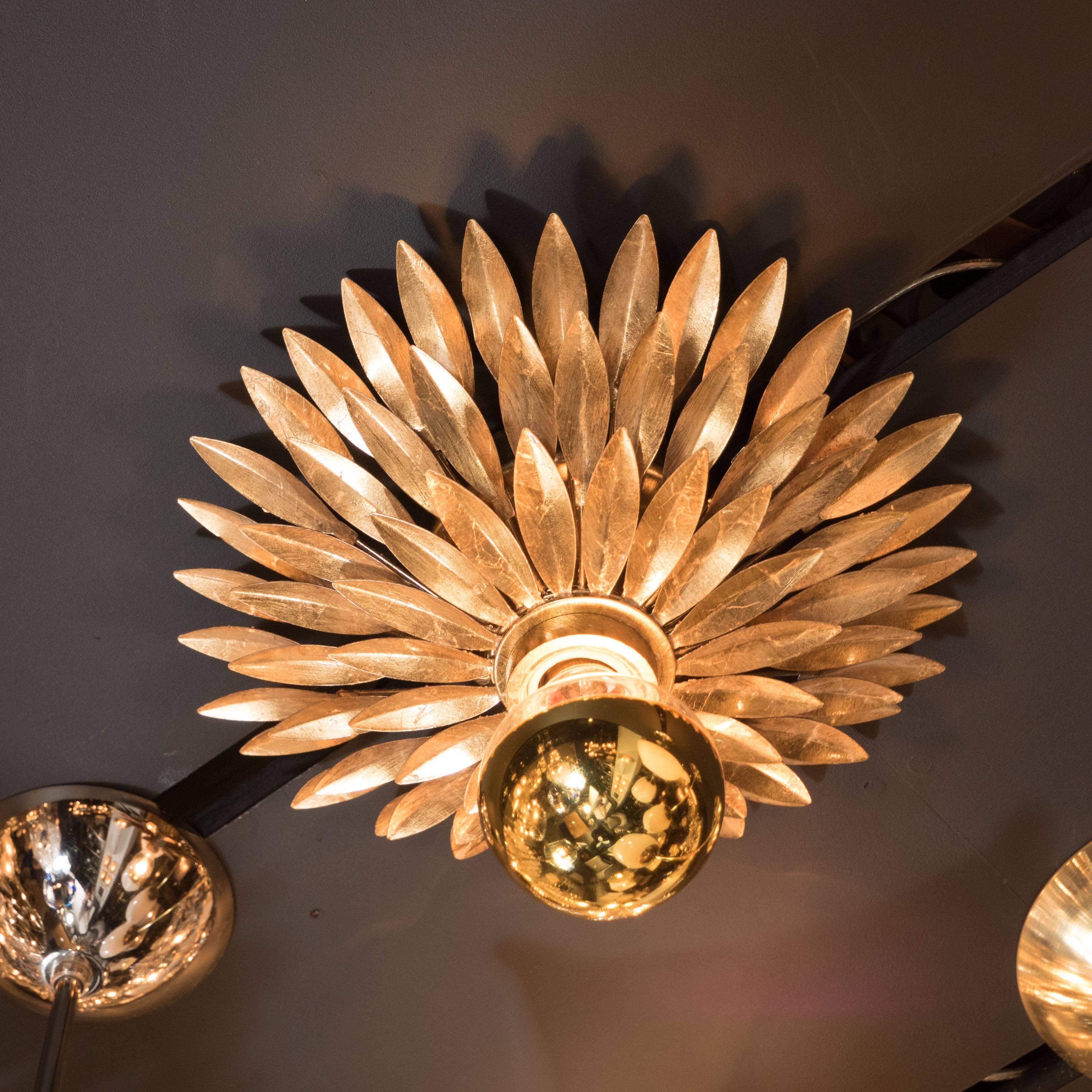 A pair of Hollywood Regency flush mount chandeliers with gilded leaf starburst detailing. A central Edison-based socket is surrounded by three layers of overlapping, individually cut gilded leaves, forming a starburst pattern. The light source