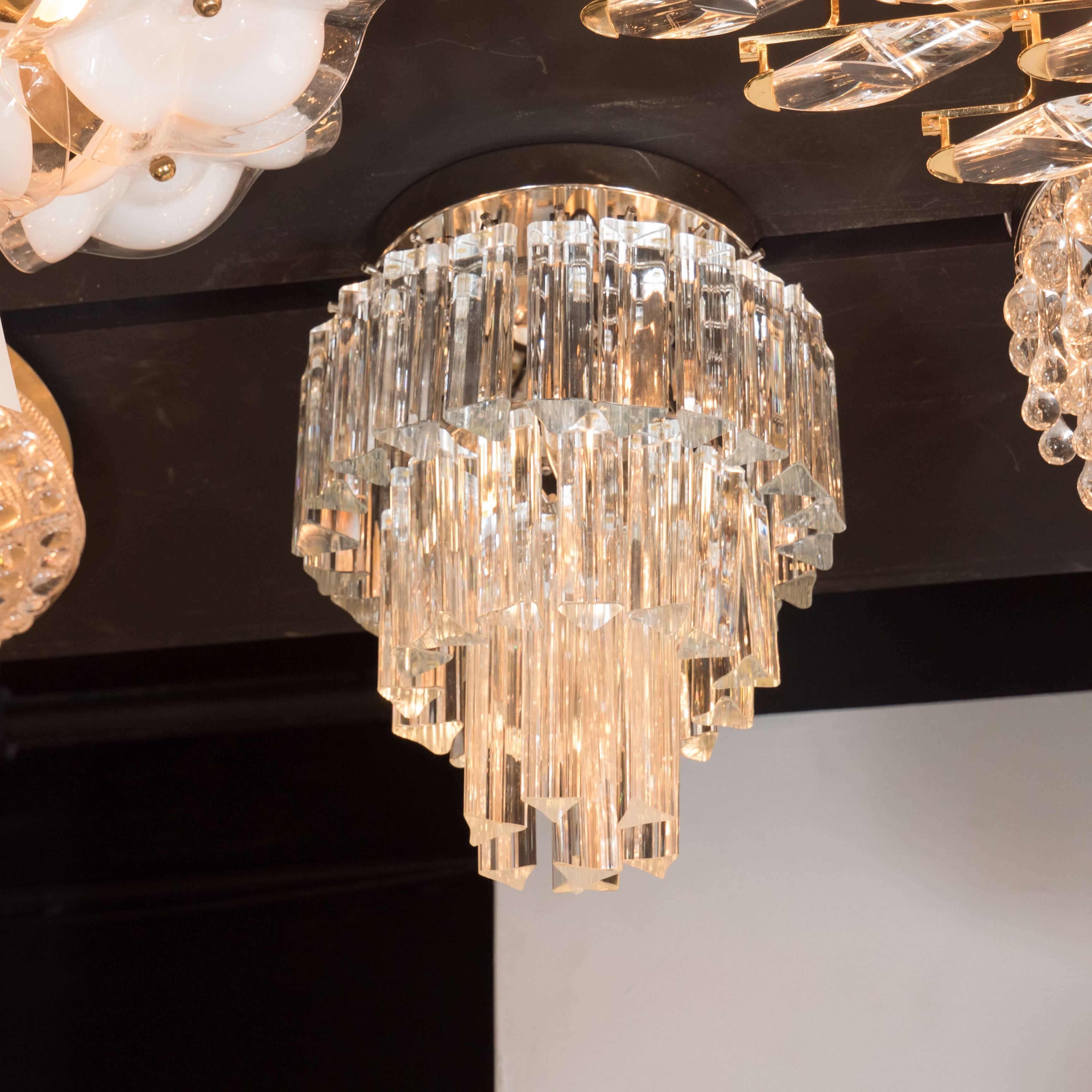 This very sophisticated flush mount chandelier features three tiers of high quality Camer Glass fitted on a chrome frame . It has been completely rewired and is fitted for three candelabra base bulbs that can be 60 watts each, so a total of 180