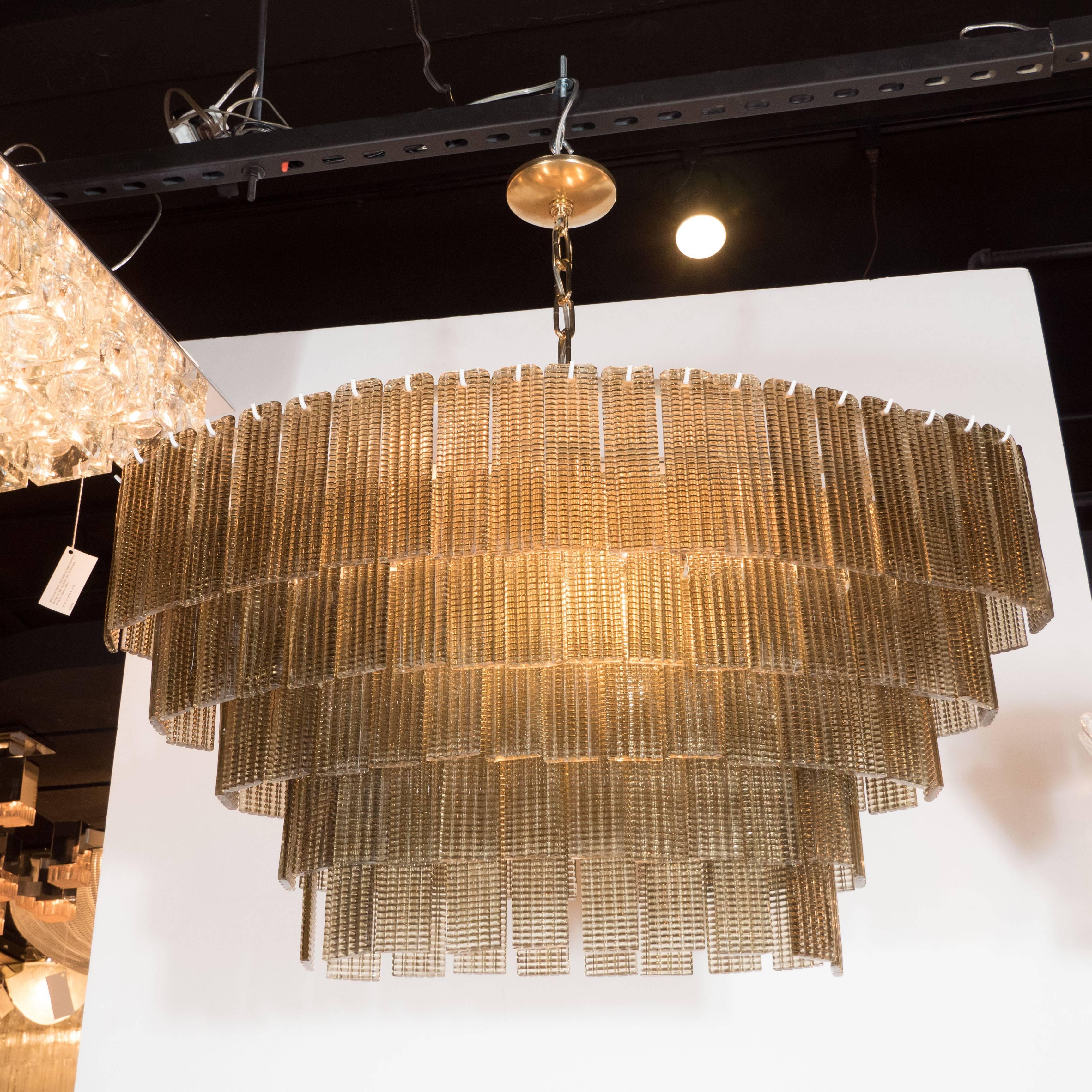 This stunning Mid-Century Murano five-tier chandelier with textured glass shades. An enameled chrome frame supports five tiers of independently hung rectangular textured glass shades in a semi-translucent gold hue. The fixture accommodates eight