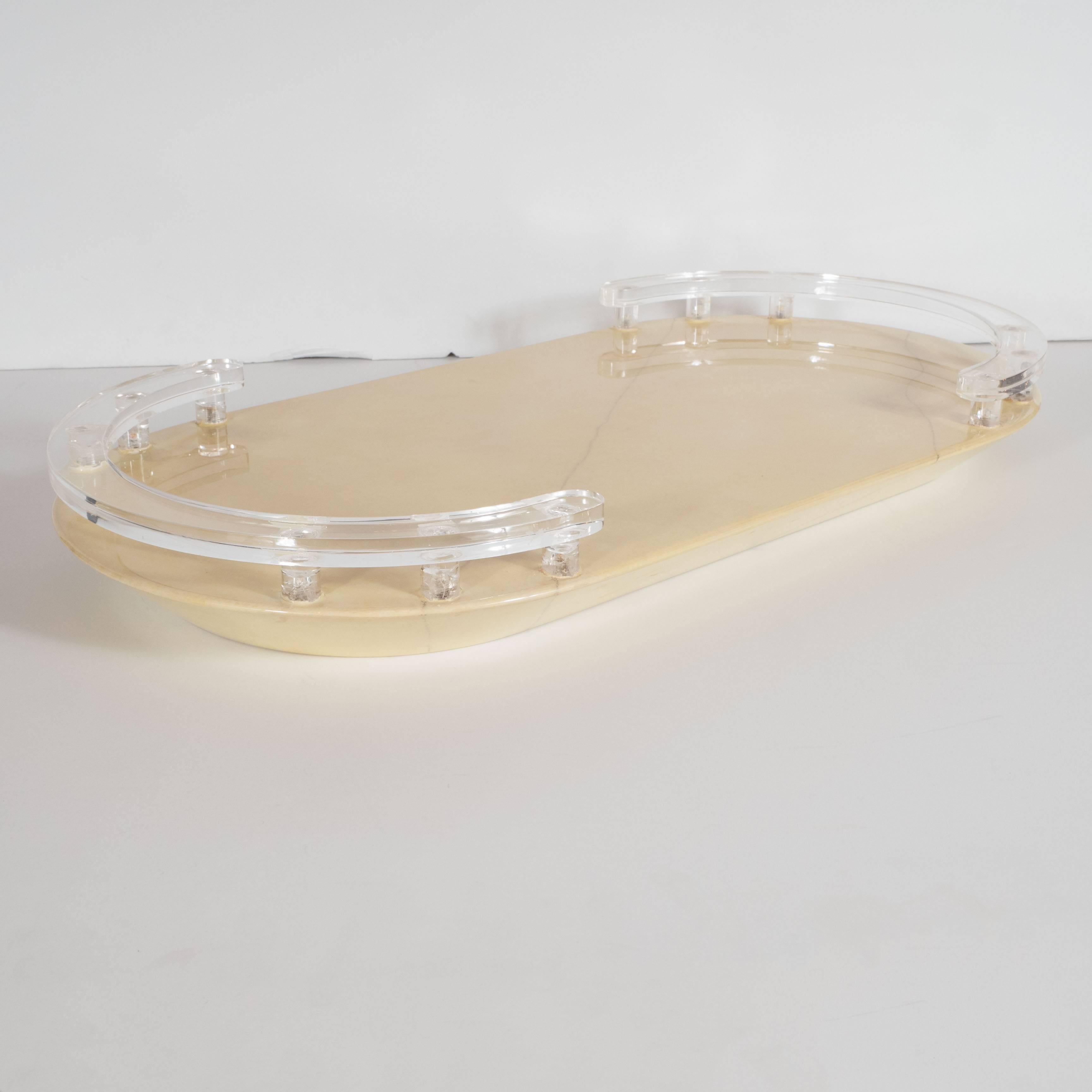 This very sophisticated lacquered goatskin tray is in hues of cream with an angled edge with a supporting Lucite rail on either end. A wonderful decorative a well as functional piece. Very much in the Manner of Karl Springer. This would make a