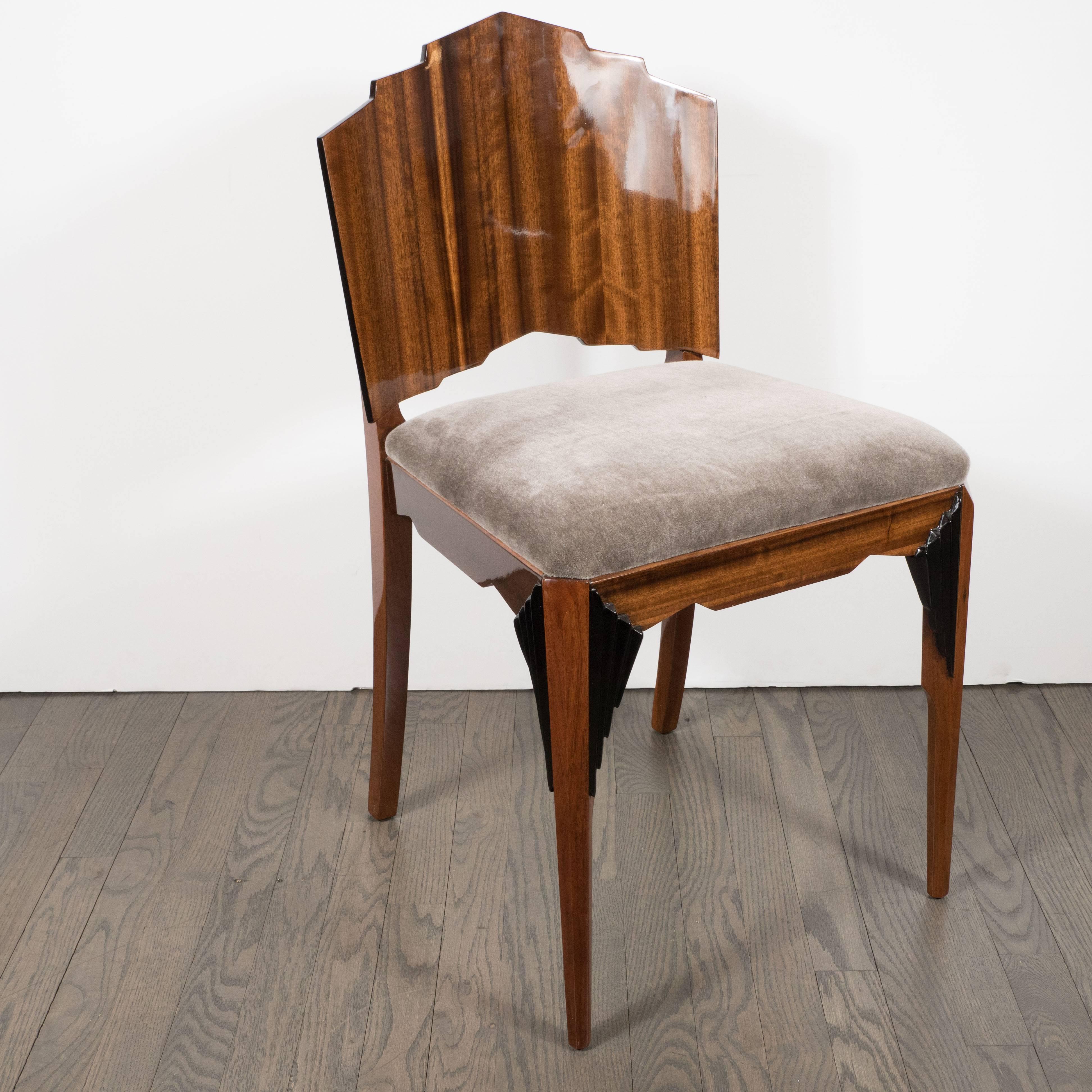 Constructed in the 1930s, this elegant Art Deco chair recalls old world craftsmanship and new world modernity with its skyscraper style tiered back made from beautiful tiger's eye walnut. It features lacquer accents tracing the perimeter of the back