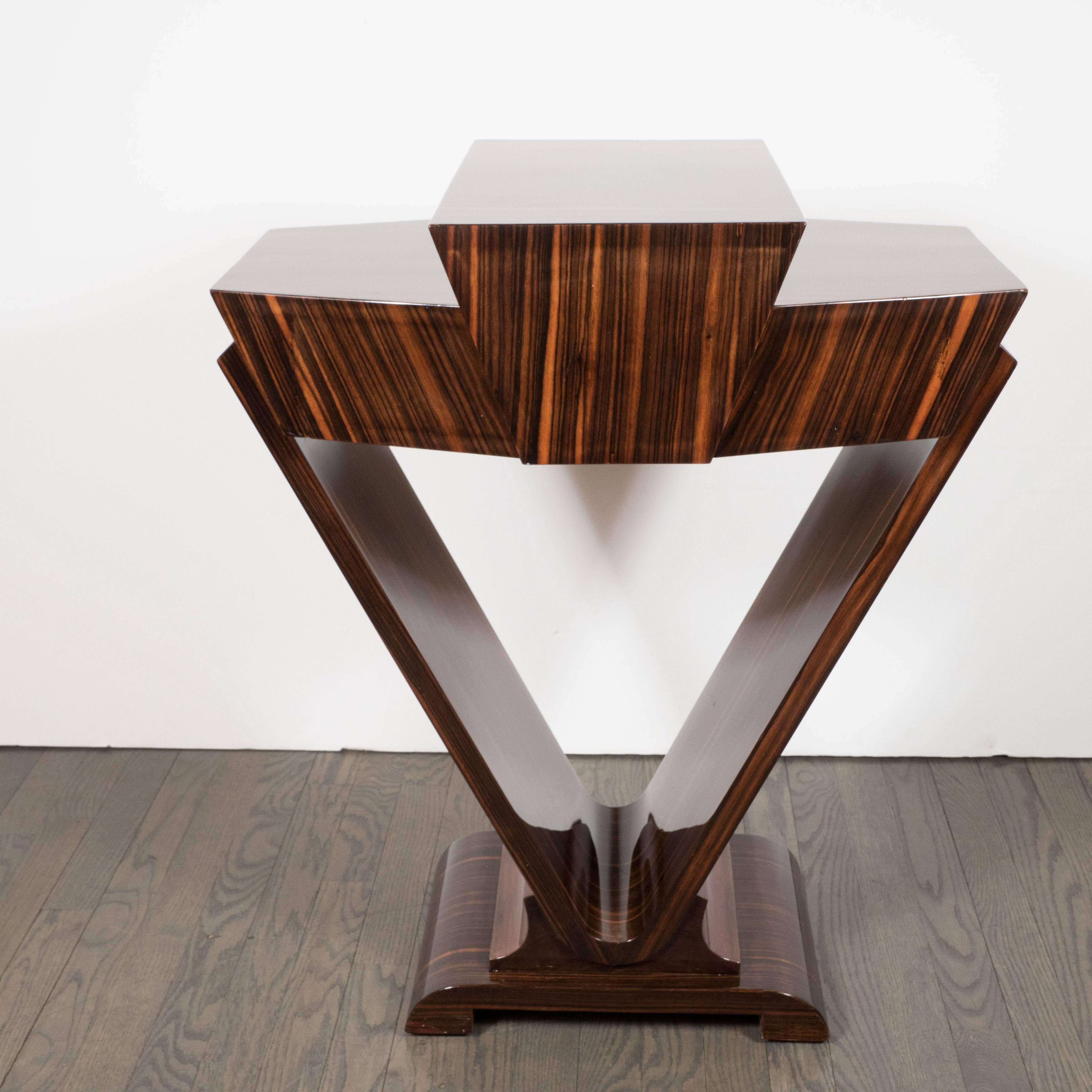 This console table features dramatically striped wood grain of exotic Macassar, consisting of sherry and coffee hues, which is complimented by the black lacquer pull to open a drawer for convenient storage The table boasts an ironically Art Deco