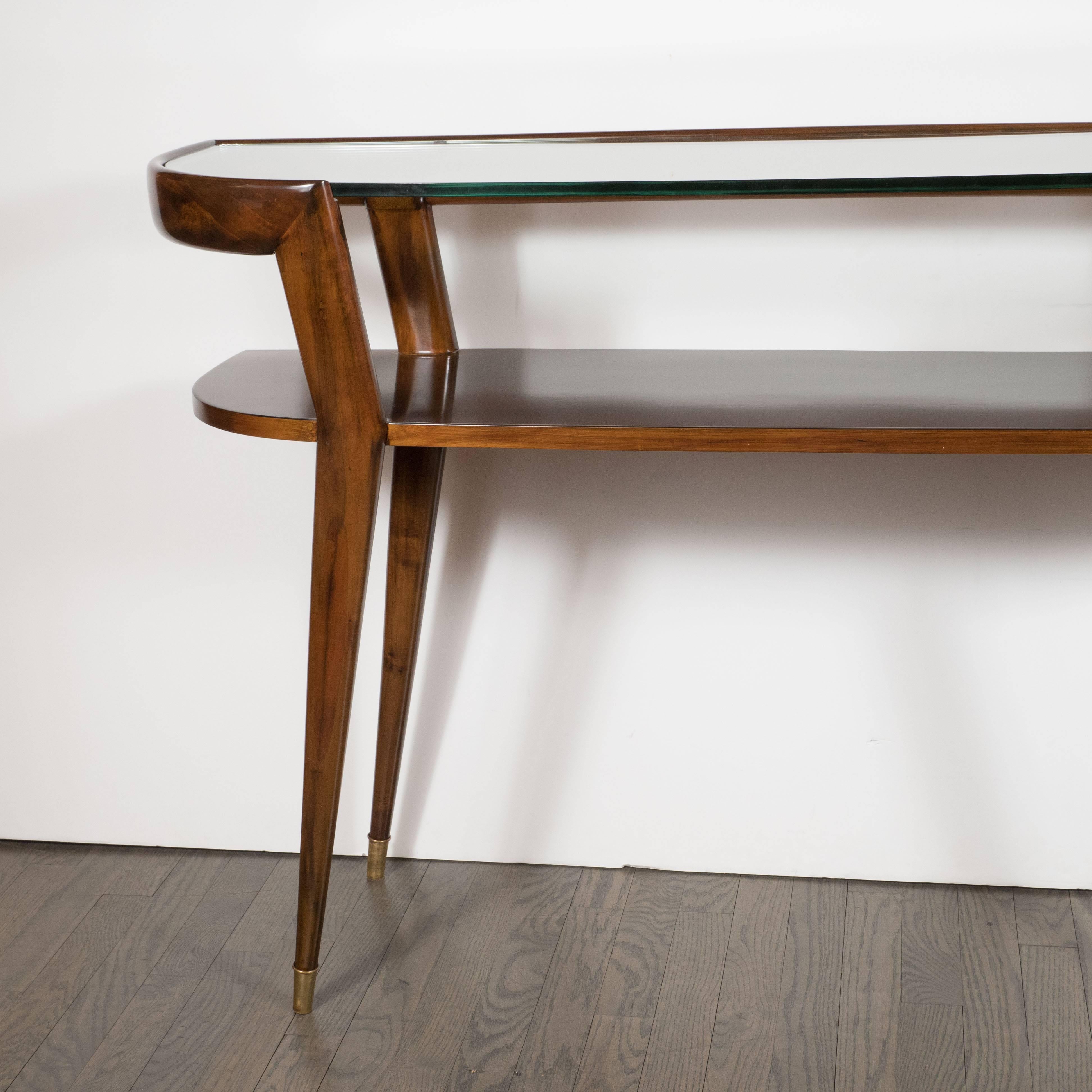 This very sophisticated Mid-century modernist two-tier console table in hand-rubbed walnut with inset glass top and brass sabots. The piece has been mint restored and in excellent condition.
Italian, circa 1950
Measures: 31.5 height
47.5