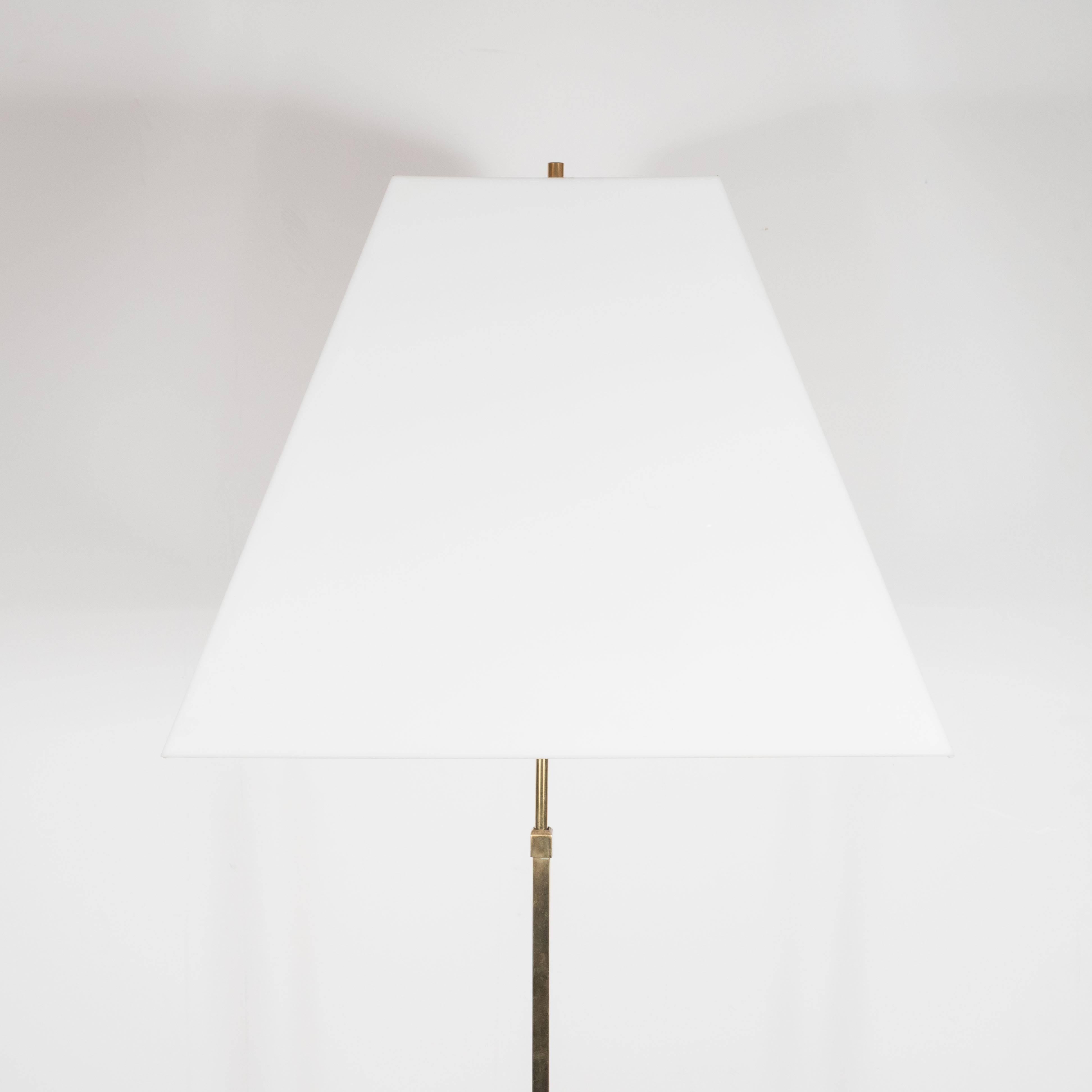 This sophisticated Mid-Century Modernist boasts a diamond base with sunburst detailing in polished brass. The stem features a stepped skyscraper design, supporting a custom white Lucite shade with original brass finial. It has been completely