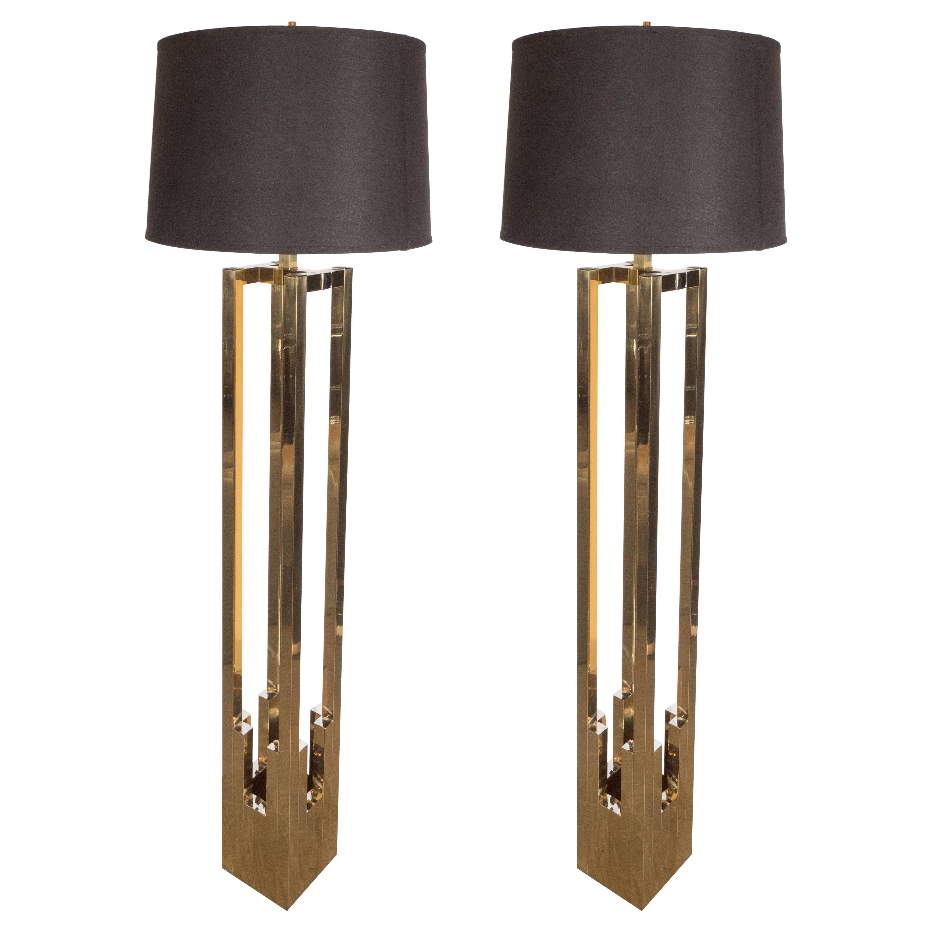 This sophisticated pair of Mid-Century Modernist floor lamps by Willy Rizzo for Lumica, features skyscraper style stepped detailing in contrasting polished brass with chrome accents. Each fixture holds (2) 100 watt Edison-base bulbs and features