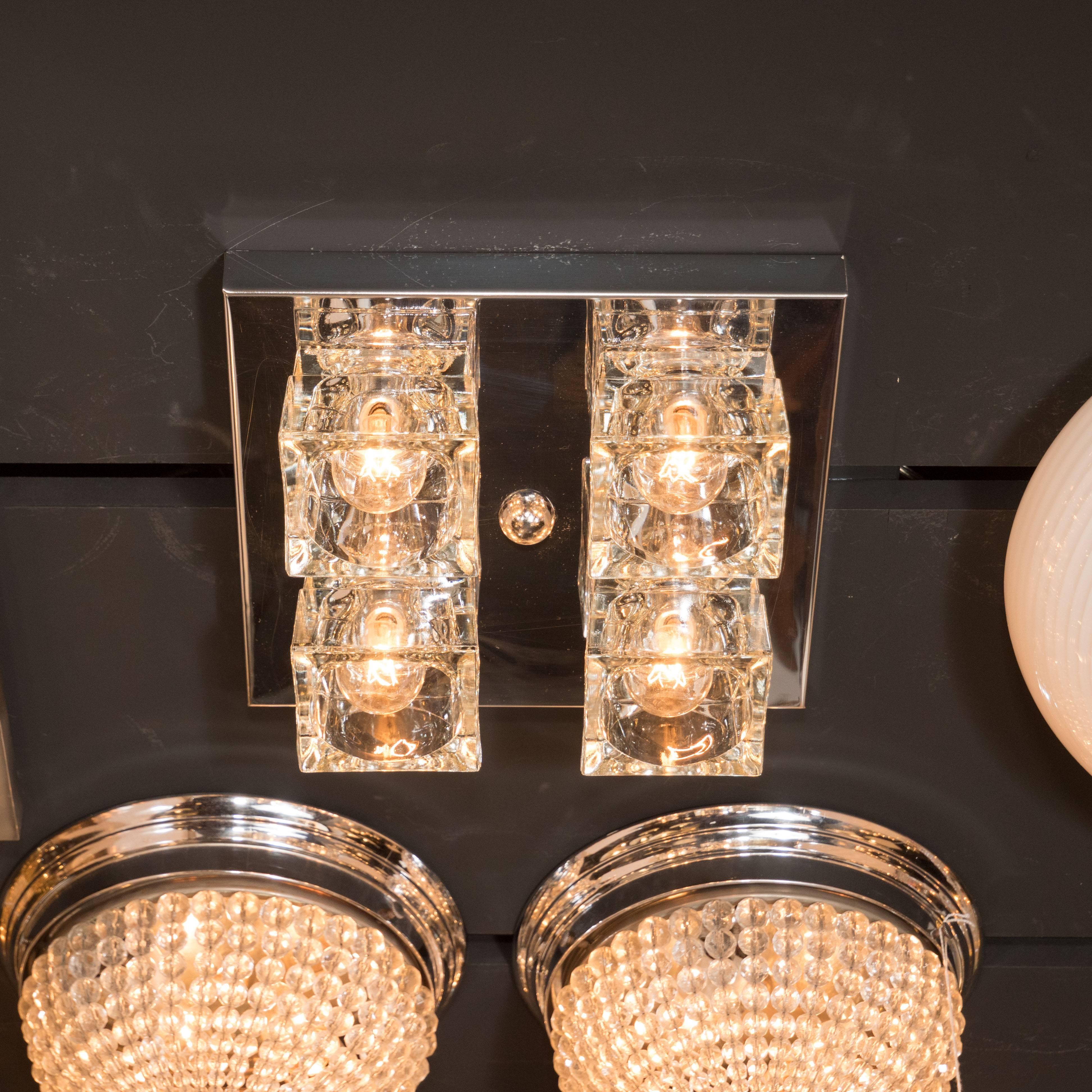 This brilliant Mid-Century Modern flush mount chandelier by Sciolari features four thick clear glass cubes with inset bulbs fixed to a close fitting chrome backplate. The design has strong geometric qualities with the cubes of the glass strongly
