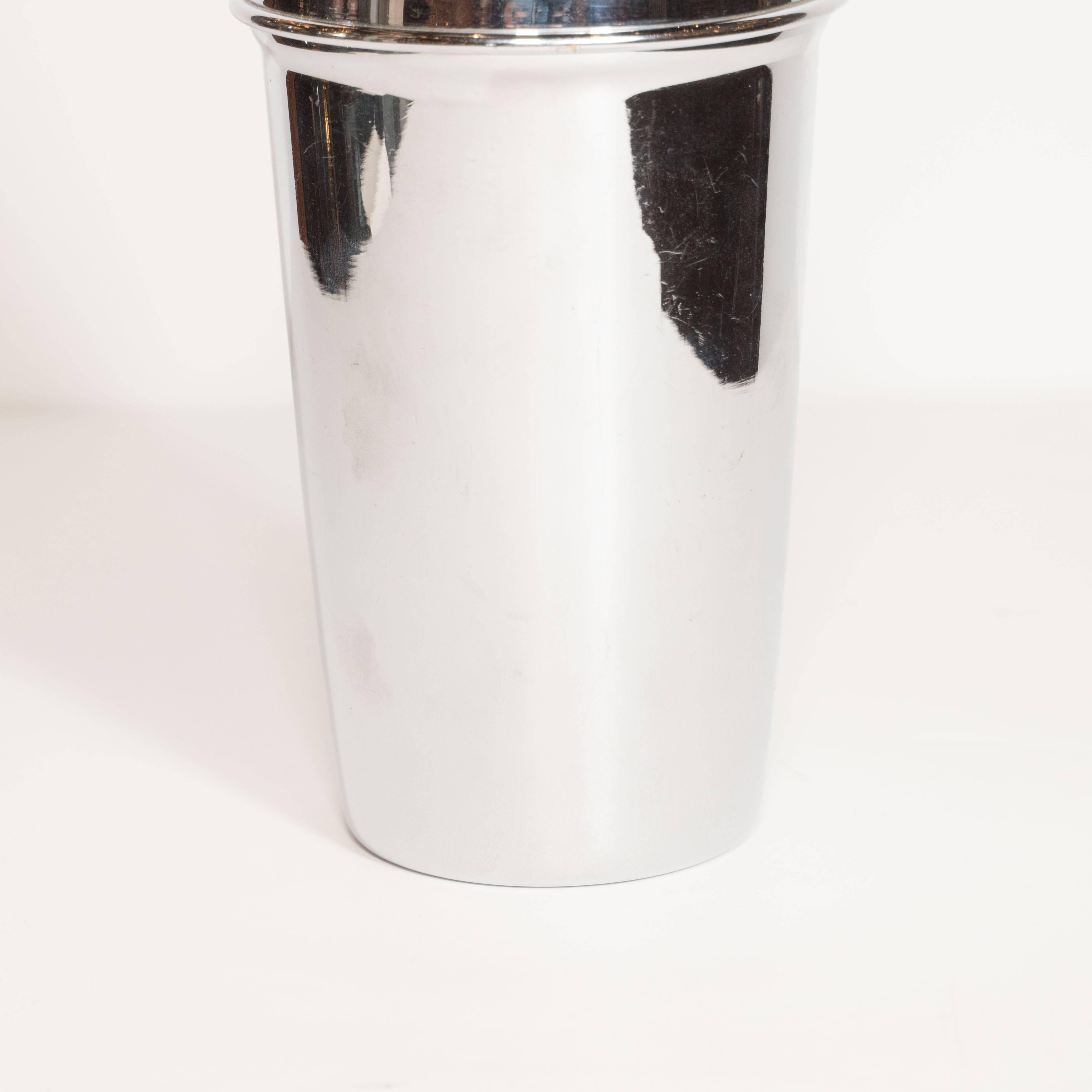 This Italian chrome cocktail shaker is made of chrome, features a removable top with a built in strainer. Its clean lines recalls Machine Age Art Deco design. It would be an elegant addition to any bar set. Excellent condition.

Italian, 20th
