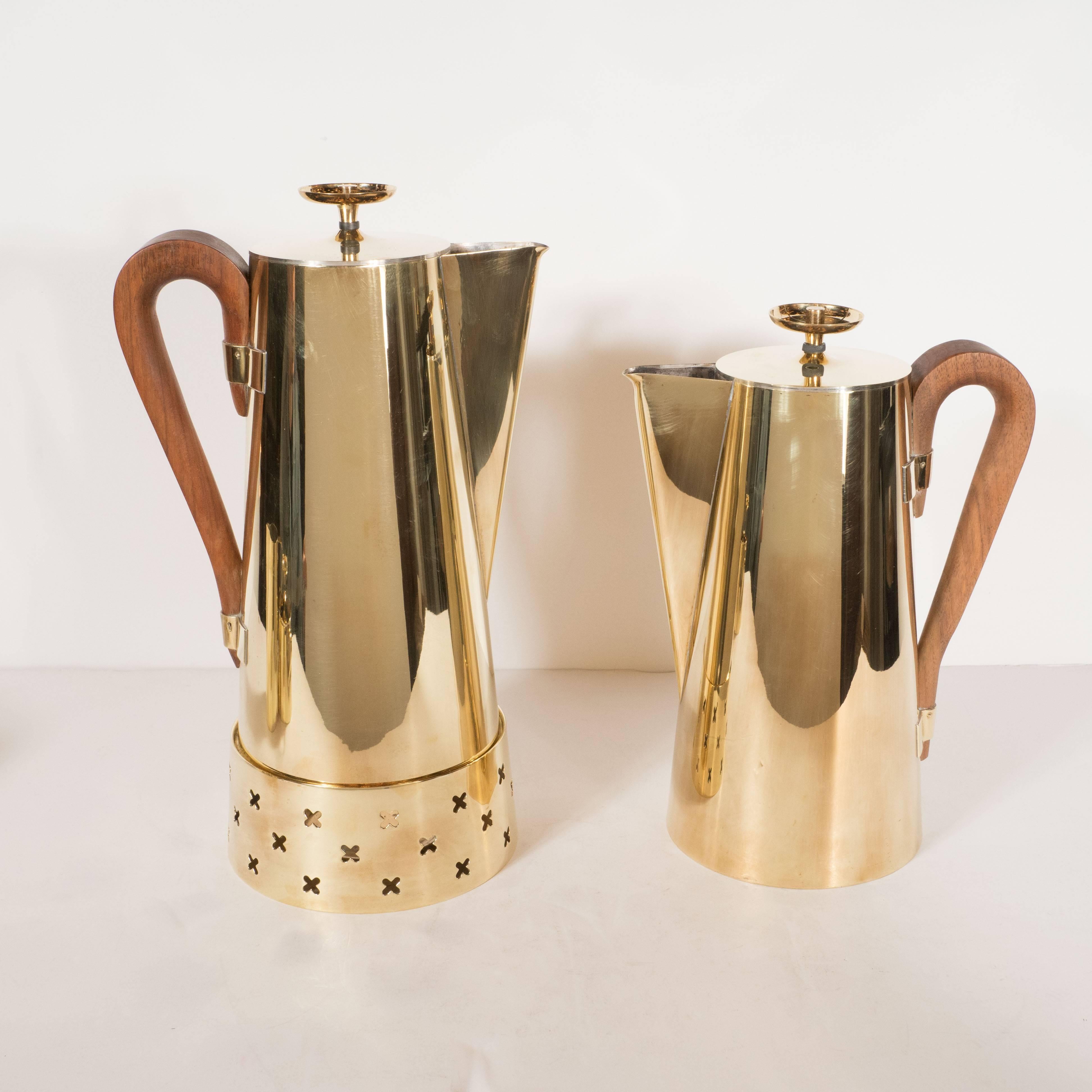 This gorgeous coffee or tea service set was designed by Tommi Parzinger, among the most celebrated Mid-Century Modernist designers, for Dorlyn Silversmiths. The set includes one large coffee pot, one medium tea pot, a creamer, and a sugar bowl with
