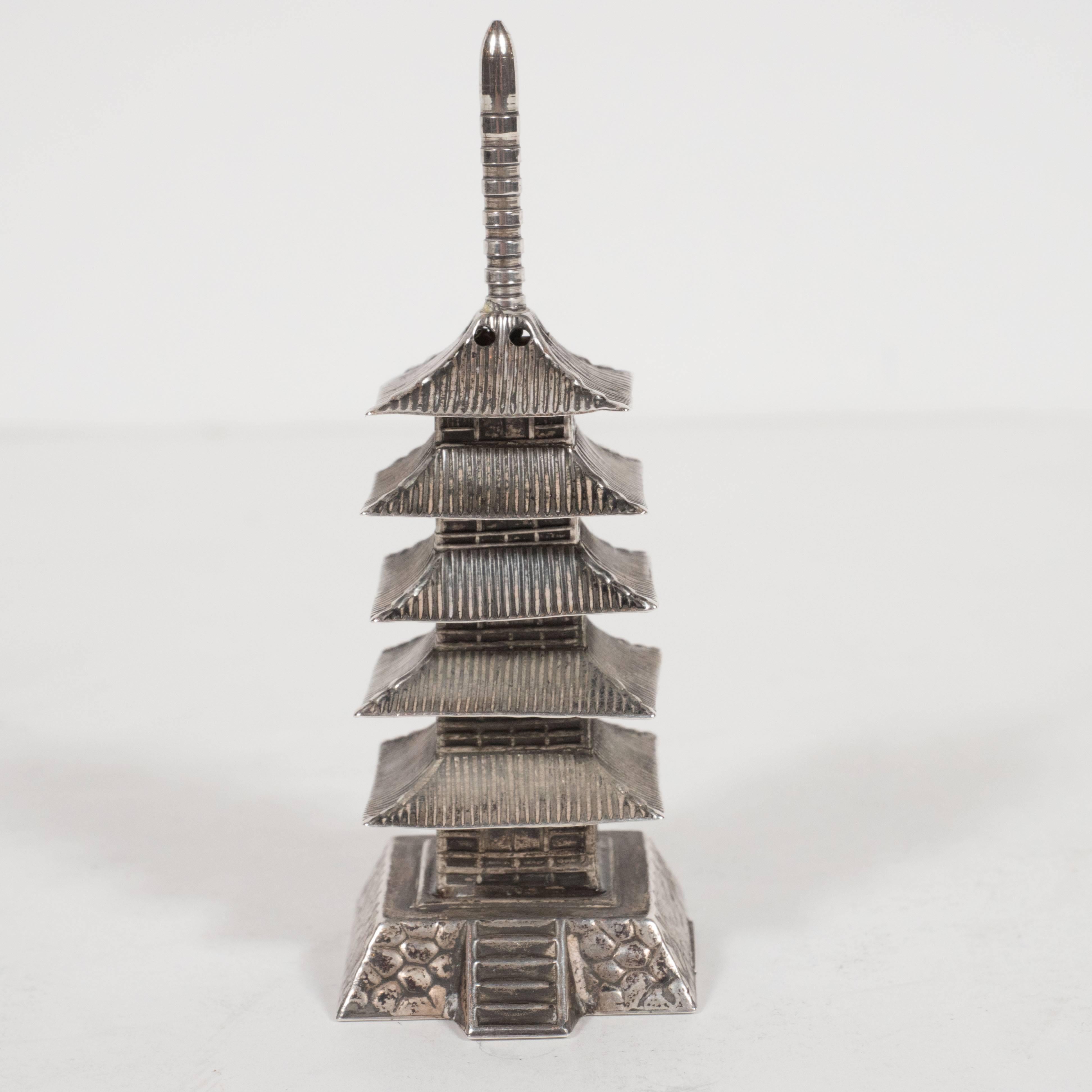 Composed of 59 grams of sterling silver, this elegant set of salt and pepper shakers were modelled after the famed Ninna-Ji temple in Kyoto. They featured a Pagoda style design, complete with a staircase, a stone wall, and a tiered roof crowned with