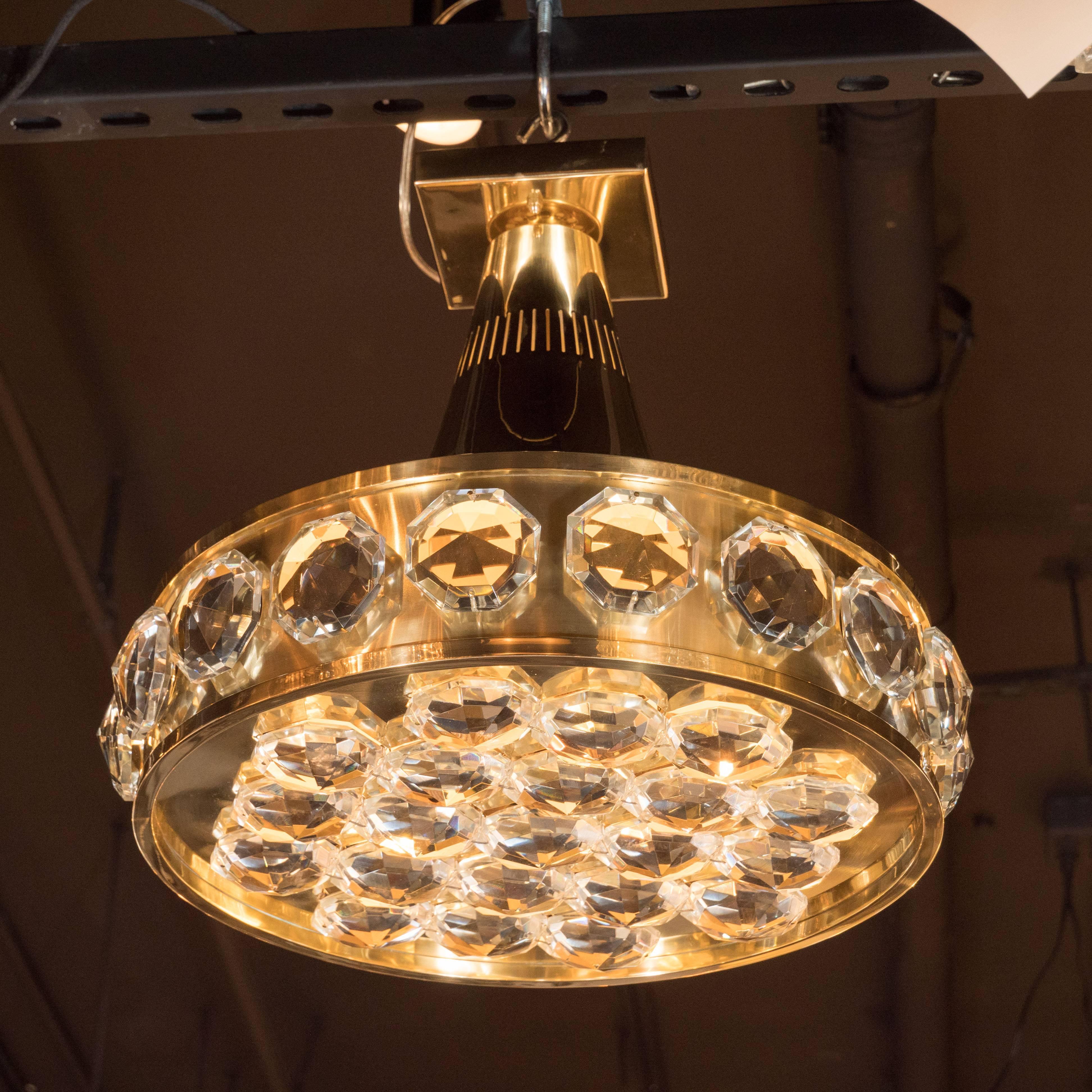 These glamorous Bakalowits & Sohne cut crystal and polished brass flush mount fixtures appear like a scattering of brilliantly illuminated diamonds in a gold setting. Additionally, there are vertical perforations circumscribing the top of the