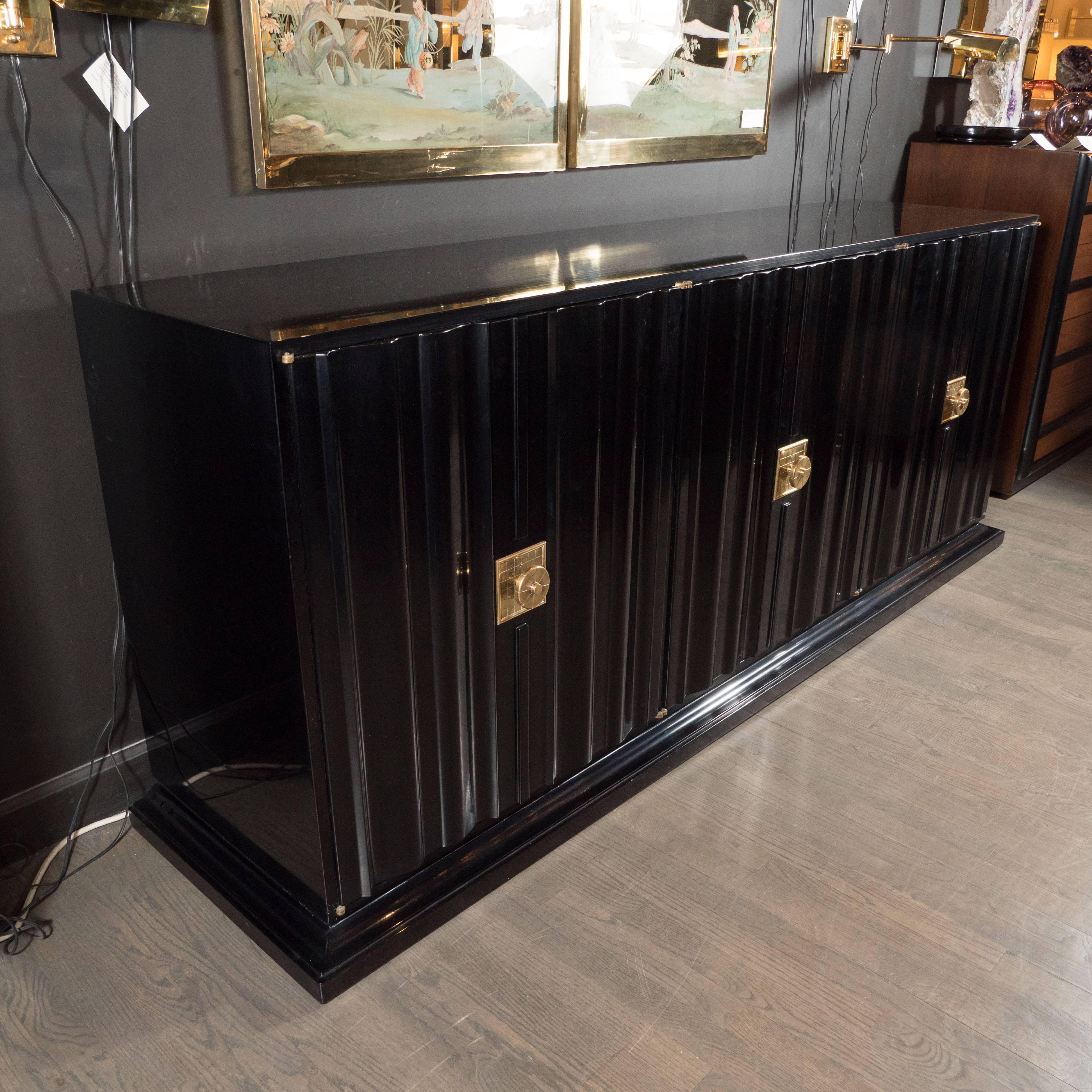 Tommi Parzinger is celebrated as one of the pioneers of high style modernism, a combination of cosmopolitan clean design and sumptuous materials. This credenza represents an important and particularly entrancing example of his practice. It features