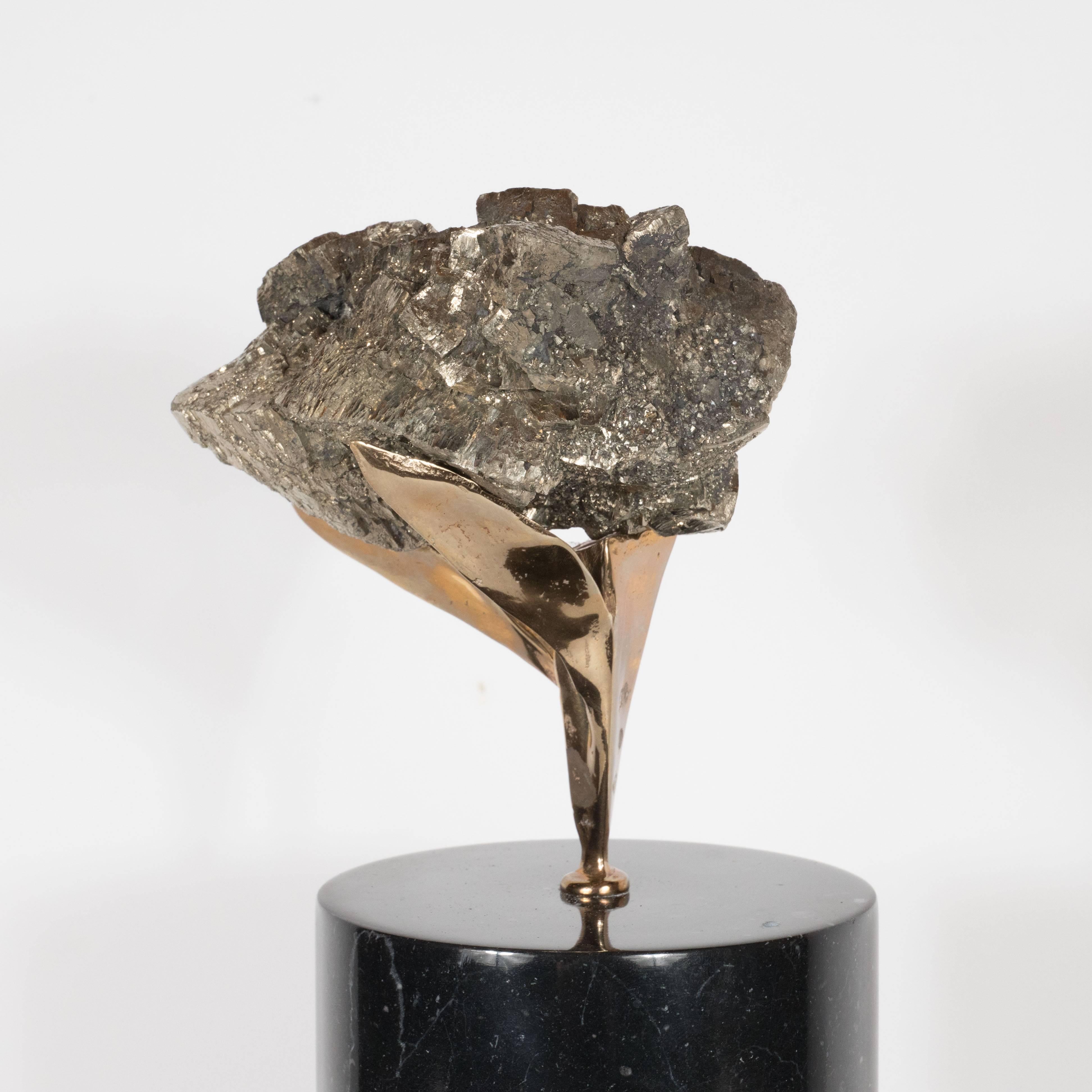 This sculpture consists of a hunk of pyrite, a mineral whose tone lies somewhere between silver and gold. Consequently, it is an extremely versatile color, blending with both of these precious metals hues and virtually every other color. The stone's