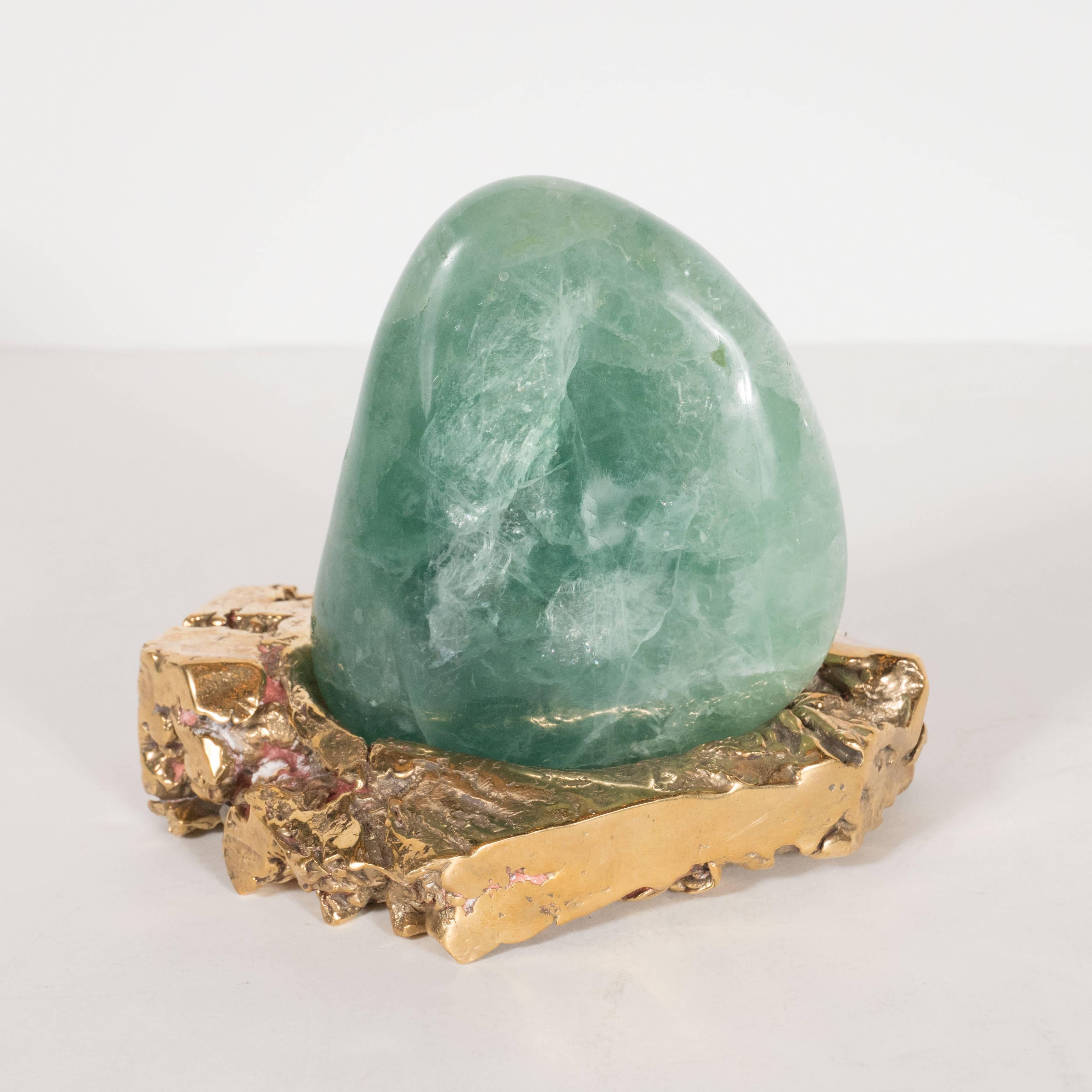 This oblong shaped green agate has been painstakingly polished and shaped to rest perfectly in its lustrous custom-made bronze base. The stone is of an entrancing milky jade hue, which pairs exceptionally well with its base forged of a particularly