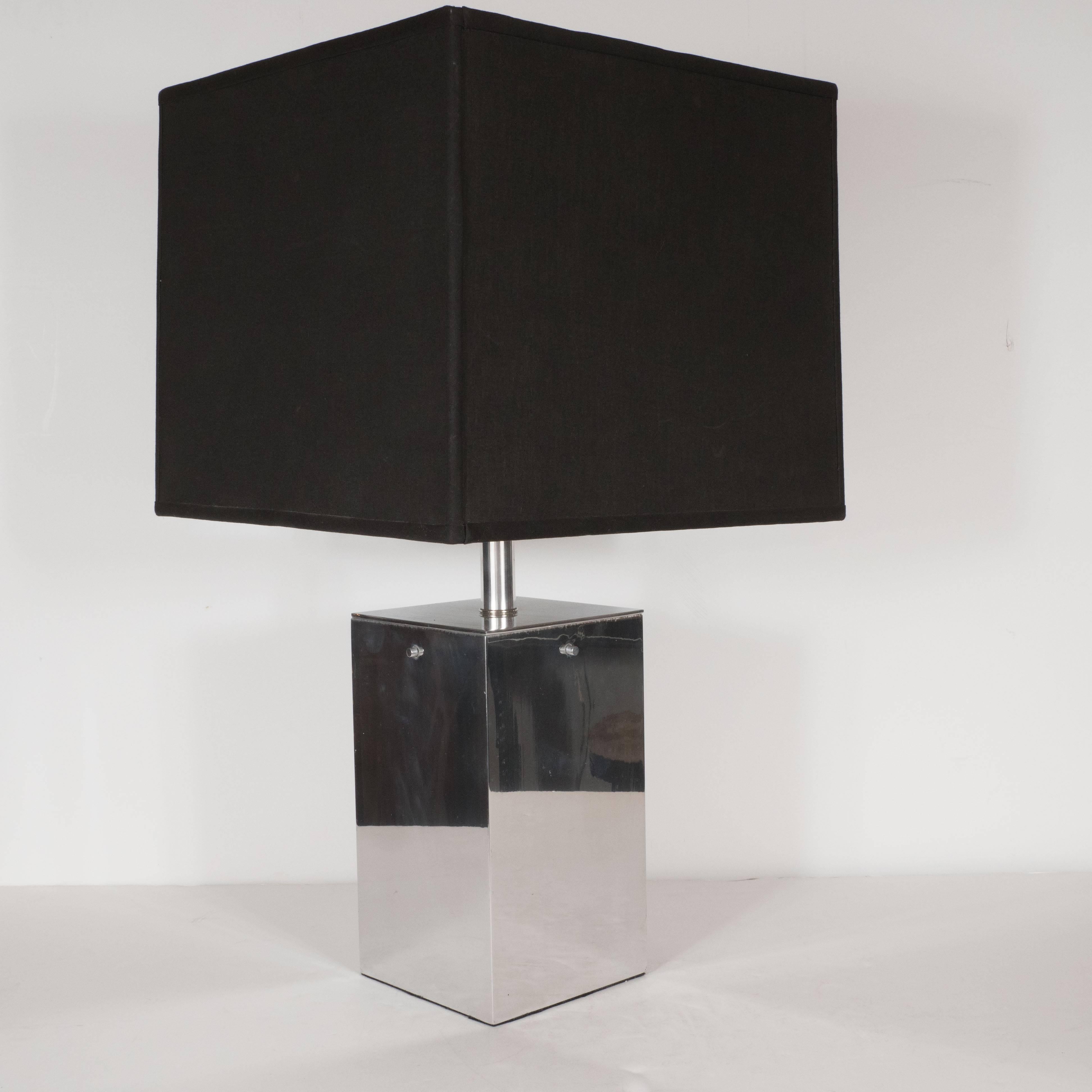 These sophisticated brushed aluminium lamps exemplify clean modern design at its best. Consisting of a rectangular cube of reflective metal, the austerity of the design naturally highlights the beauty of every element: the streamline neck that
