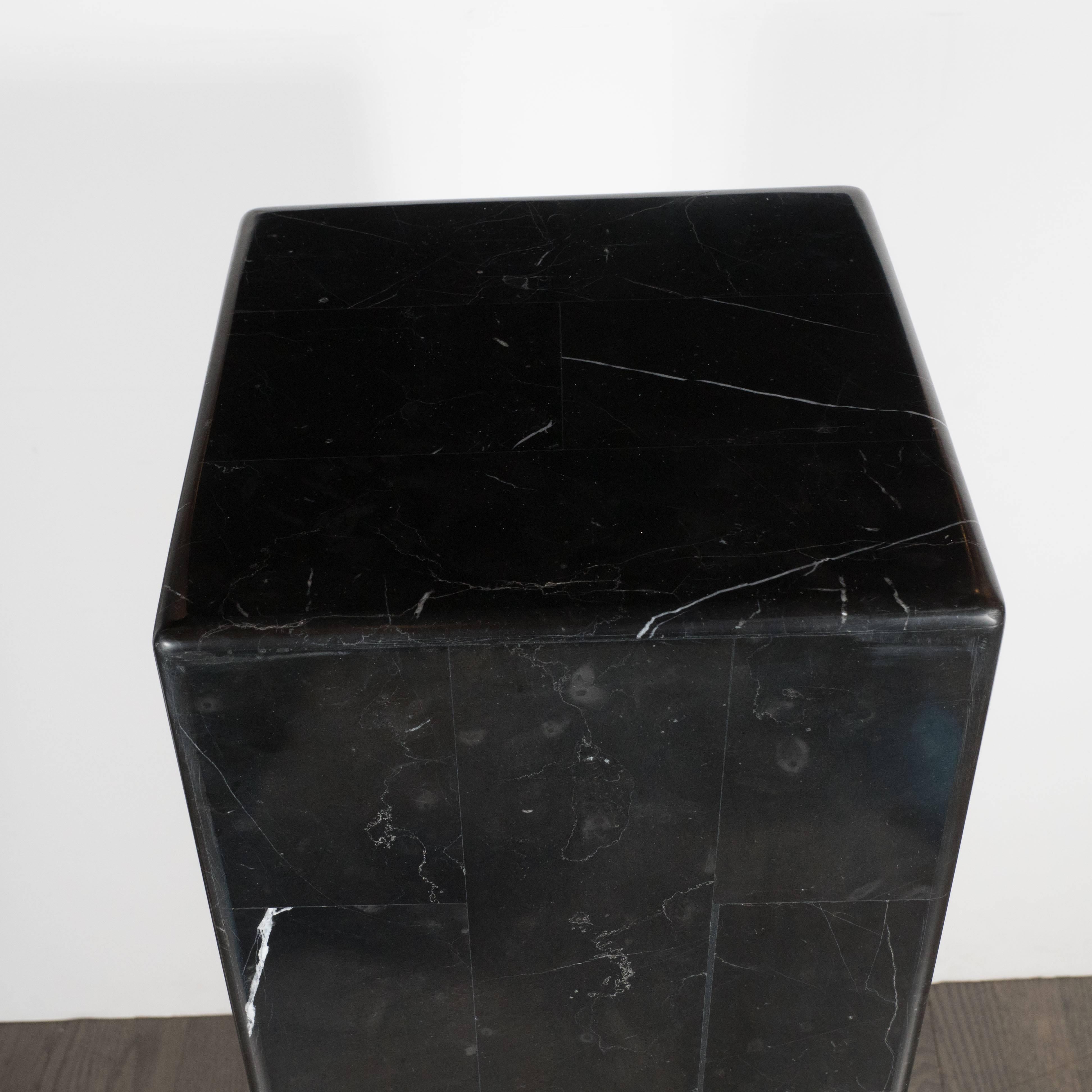 This clean modernist black Belgian marble pedestal features a simple tessellated block design, allowing the beauty of the stone to speak for itself. While the design is neutral enough to blend in with virtually any object one might choose to rest on