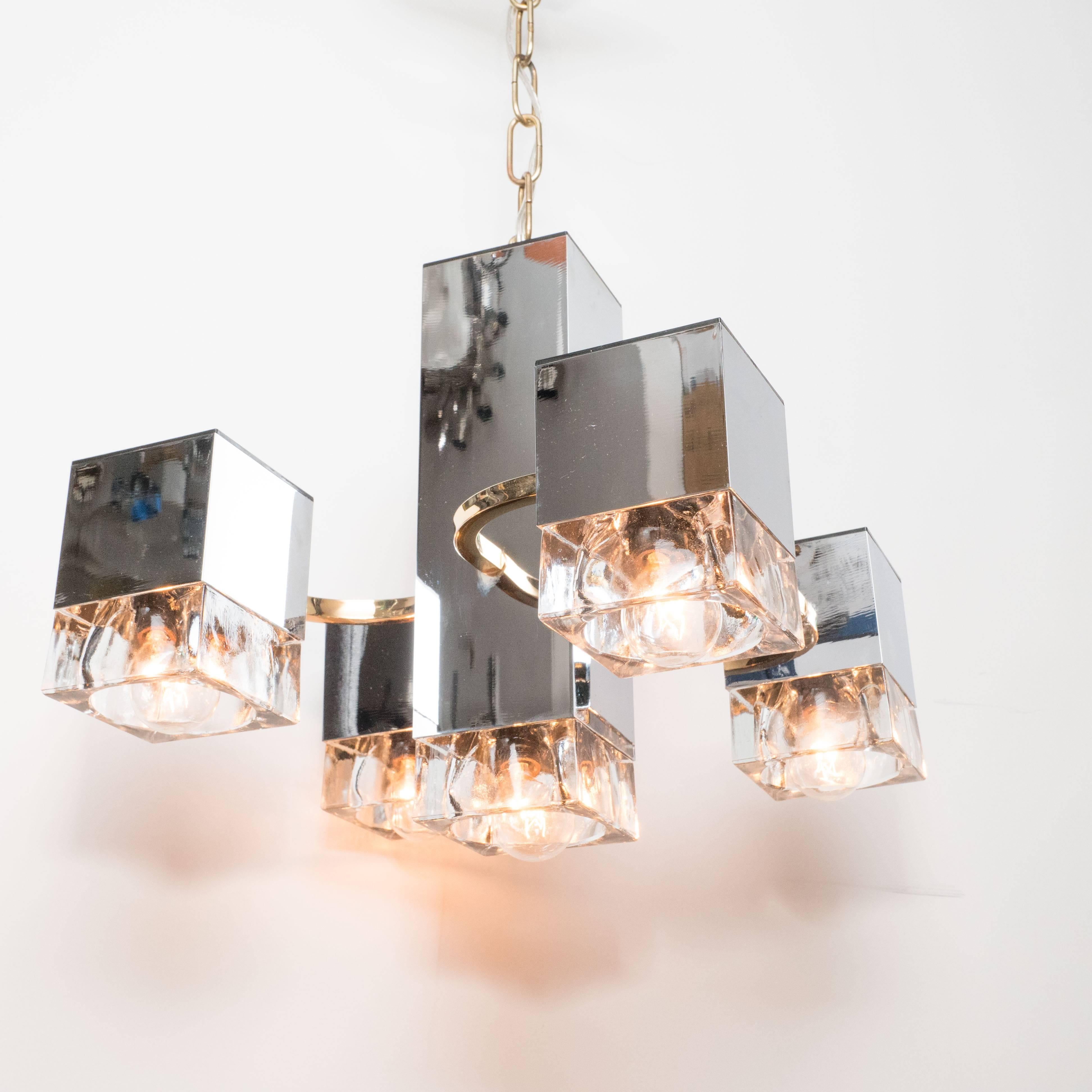 This elegant Scolari chandelier features a central rectangular pillar in chrome with four chrome cube forms attached with curved brass arms. This fixture embodies sophisticated Mid-Century Modern design at its most refined, and works well in
