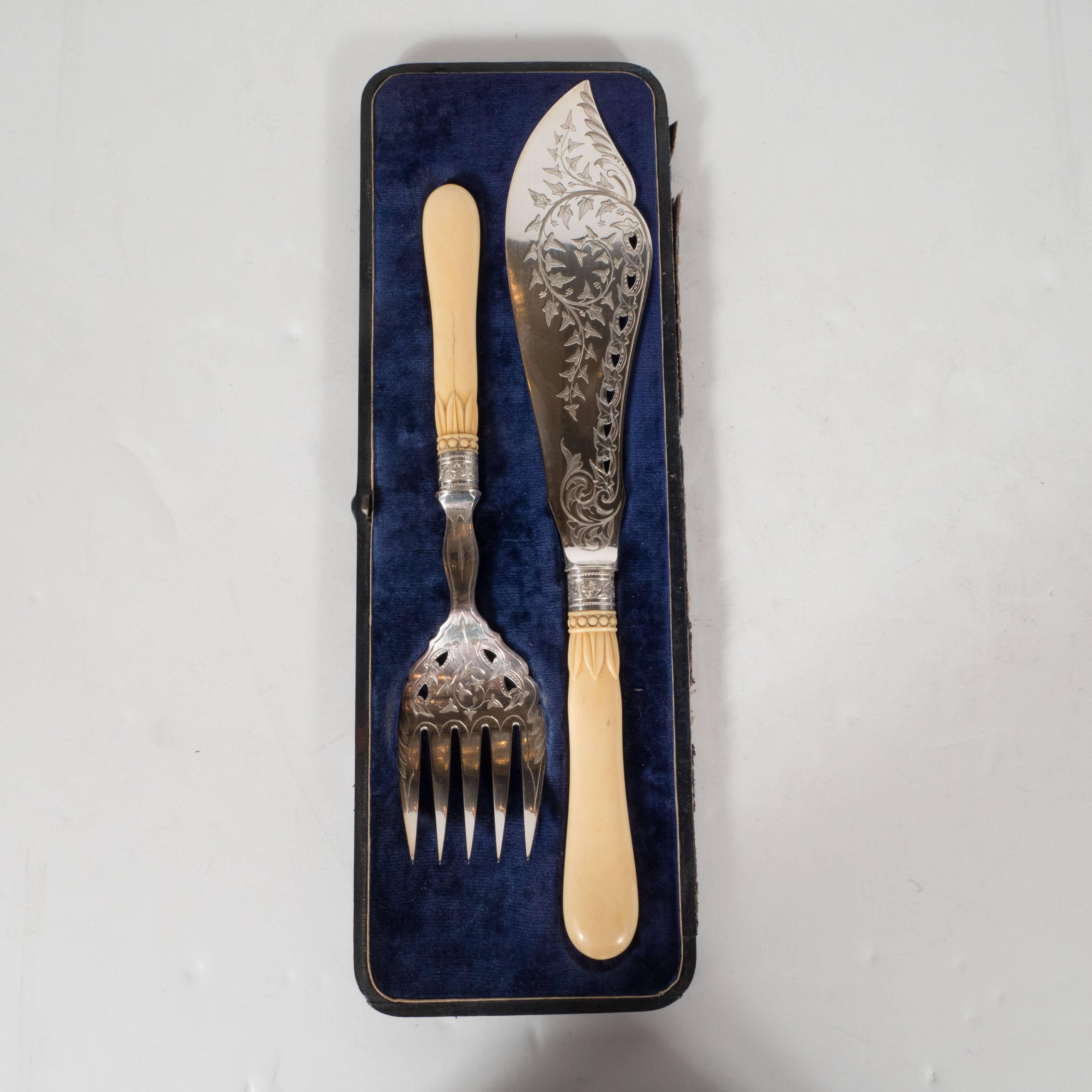 This exquisite Victorian fish set features a serving fork and knife with incredibly detailed engravings throughout. There are elaborate foliate patterns, resembling an ivy motif, as well as Baroque scrolling designs throughout. Additionally, each