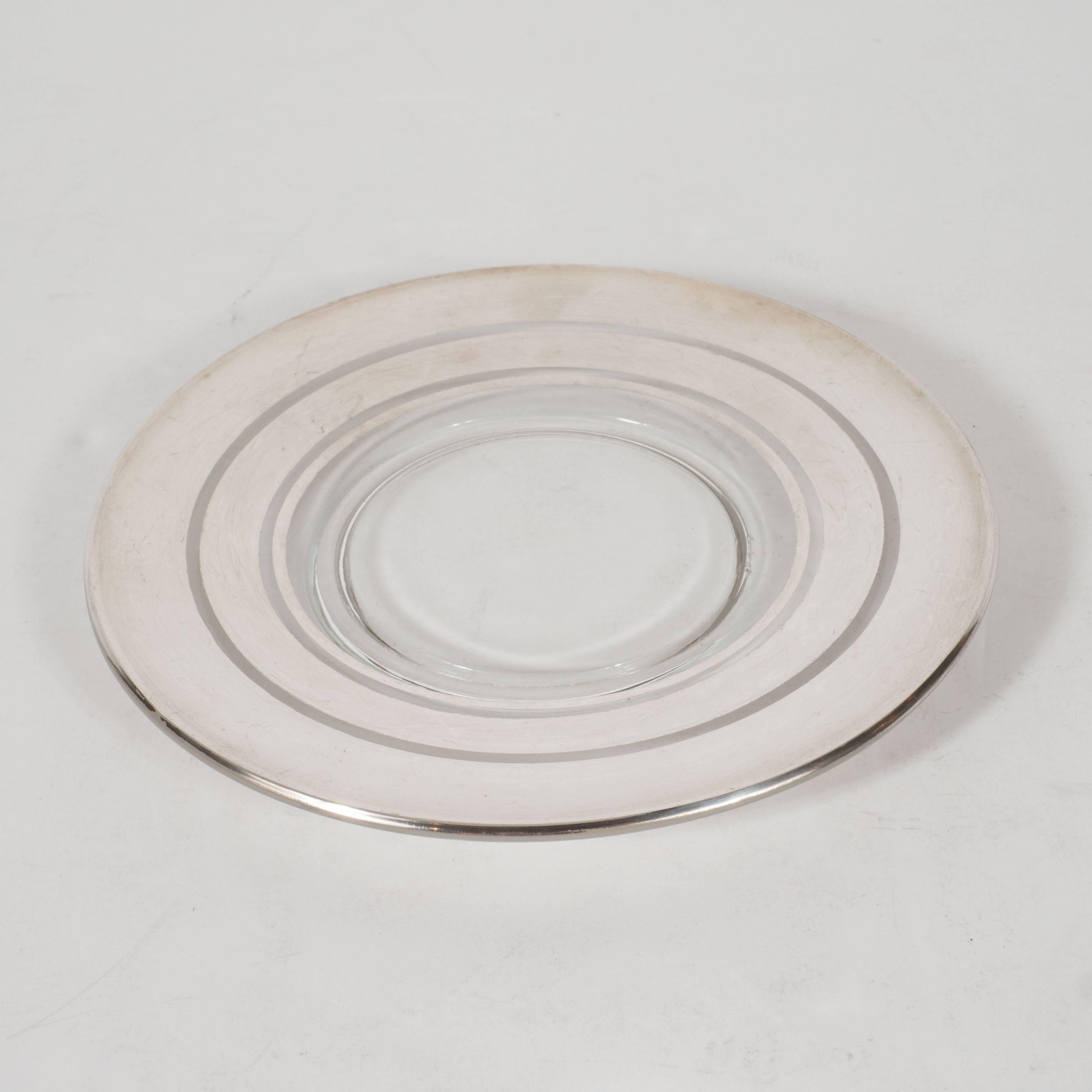 This elegant set of six Art Deco silver overlaid hors d'oeuvres plates were created by the legendary designer Dorothy Thorpe, circa 1935, during the height of Art Deco in America. They feature three concentric rings of sterling silver descending in