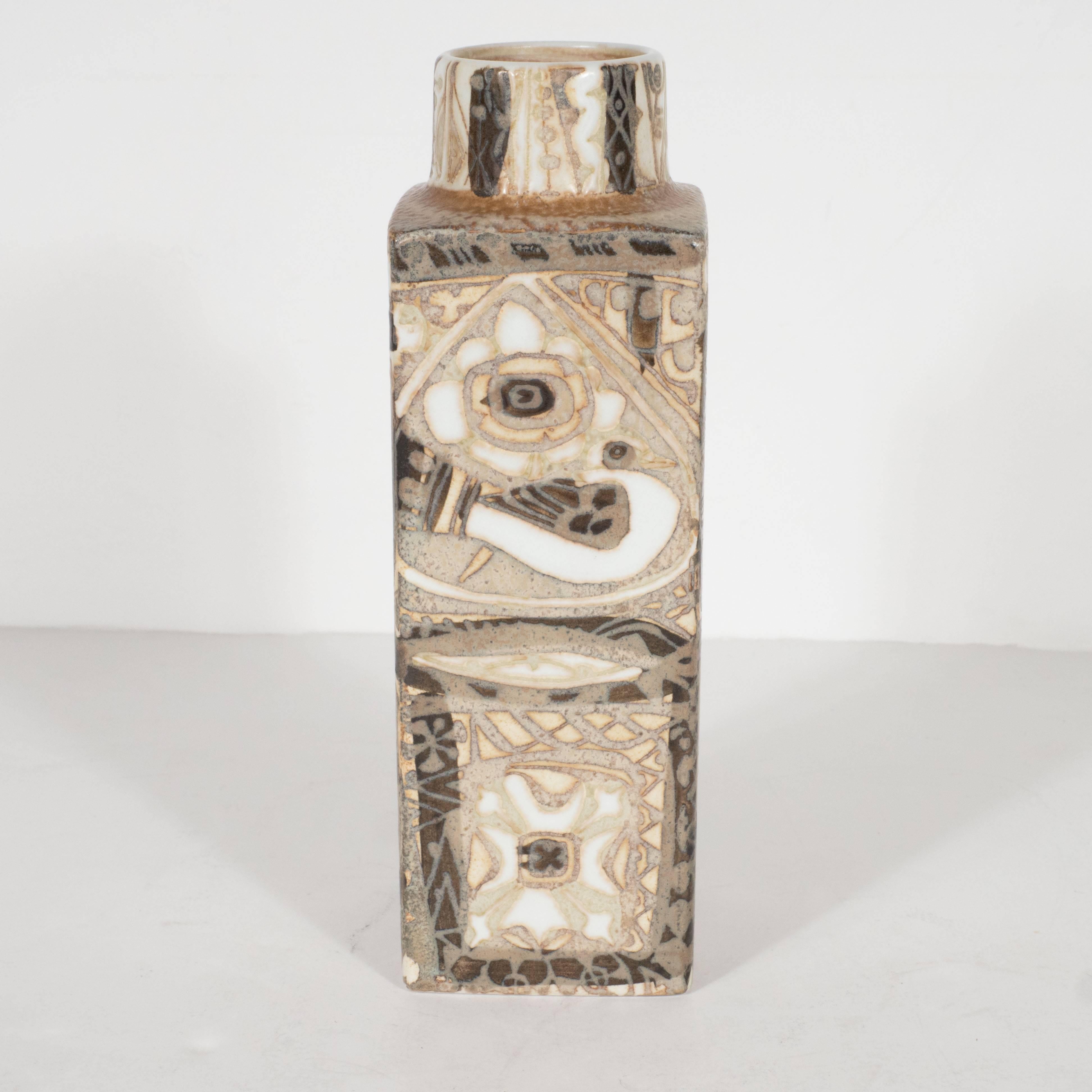 This beautiful hand-painted ceramic vase reads as a quintessentially Mid-Century Modernist piece, and a beautiful objet d'art in its own right. It features complex abstract geometric patterns throughout, as well as stylized scorpionfish in hues of