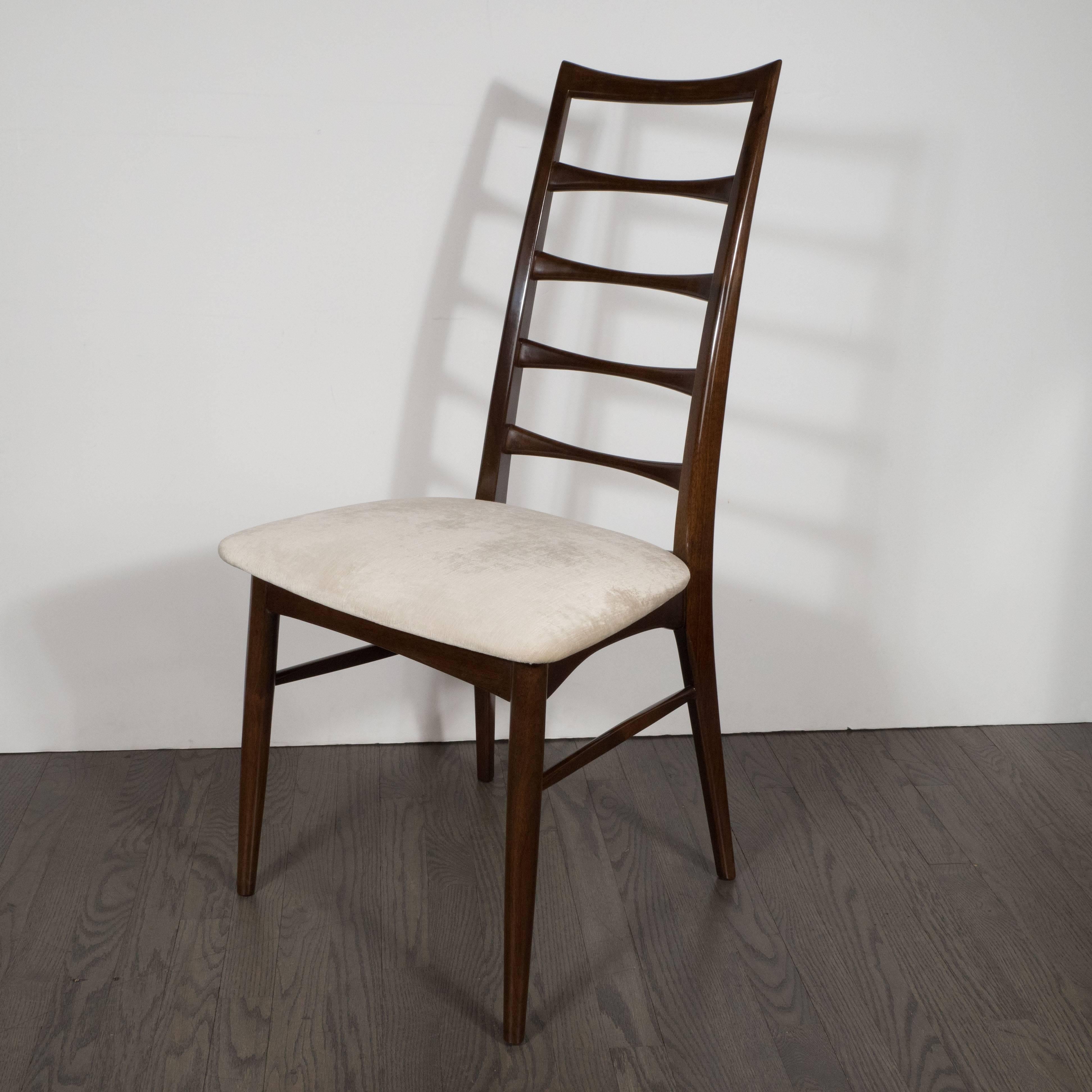 This sculptural hand rubbed rosewood chair was designed by the illustrious Danish designer Niels Otto Møller, circa 1960. It is a study in sophisticated subtle design, and a playful reinterpretation of the Classic Windsor style chair. It features a