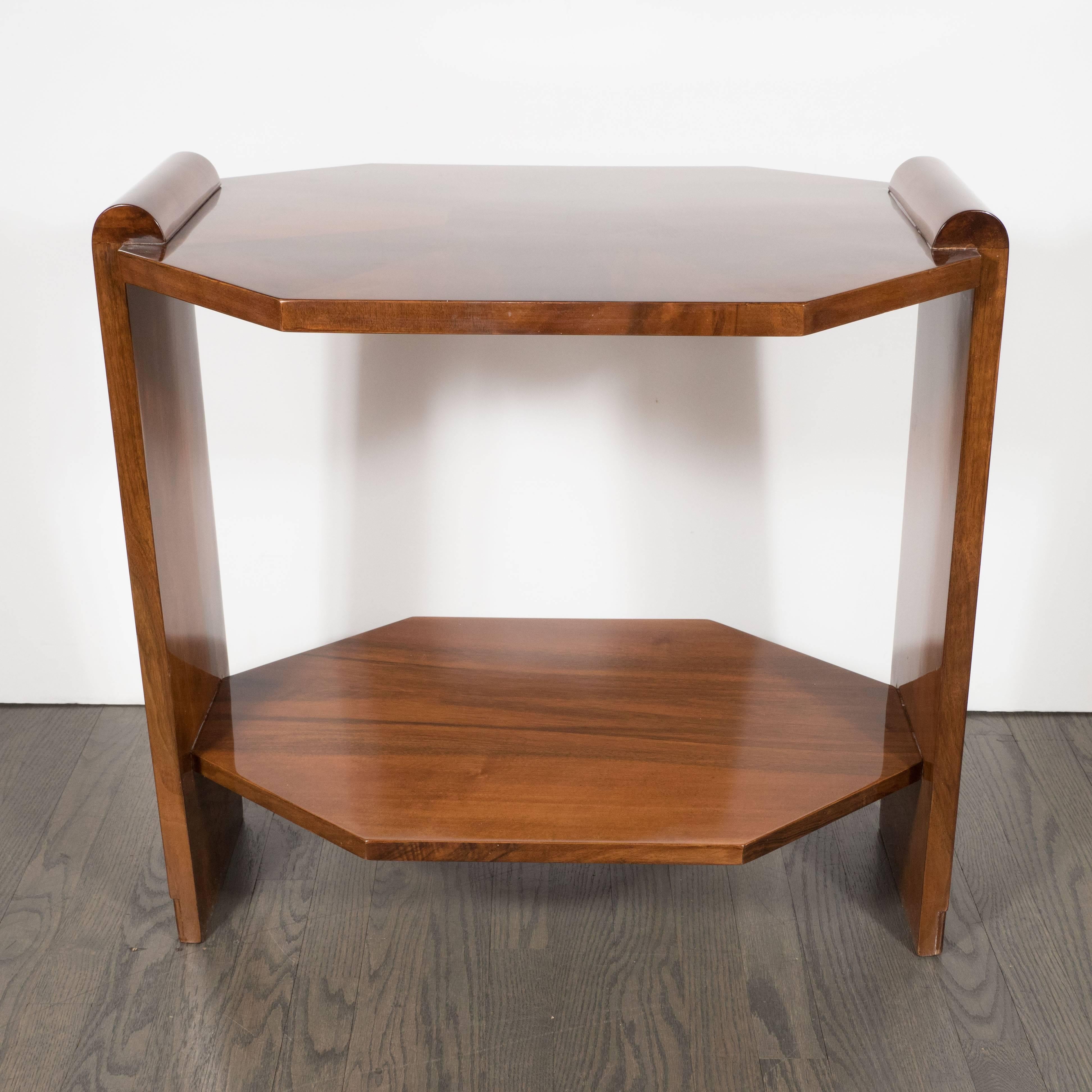 This sophisticated side occasional table features two tiers, scroll style arms with striated vertical incisions at the base, as well as inlaid and polished book-matched walnut in an octagonal geometric pattern. The top includes an octagon in the