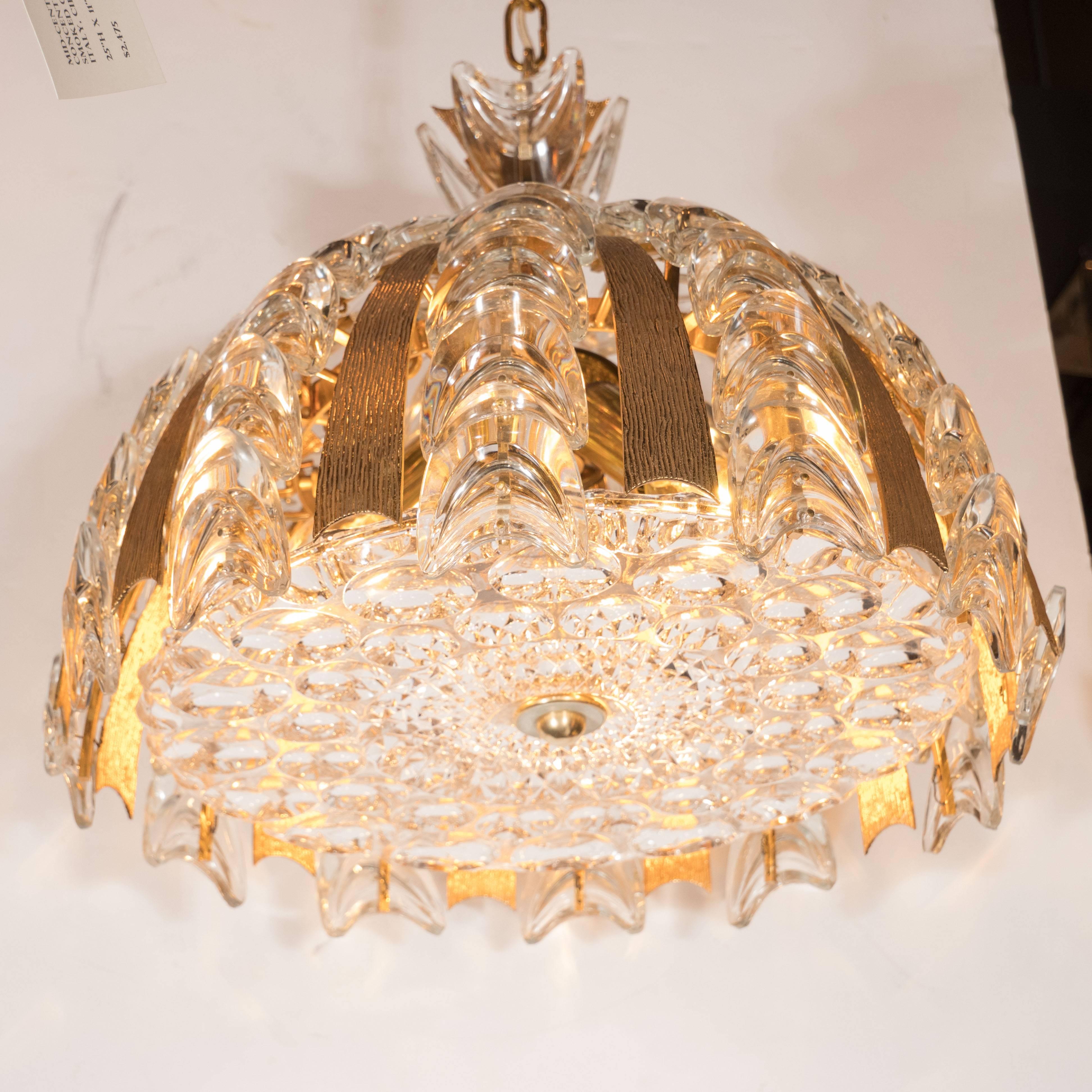 These chandeliers were crafted by the esteemed manufacturer Palwa of Germany circa 1960. The base of the fixture features two rows of concentric circles inscribed around the perimeter as well as a tessellated diamond pattern in relief in the centre.