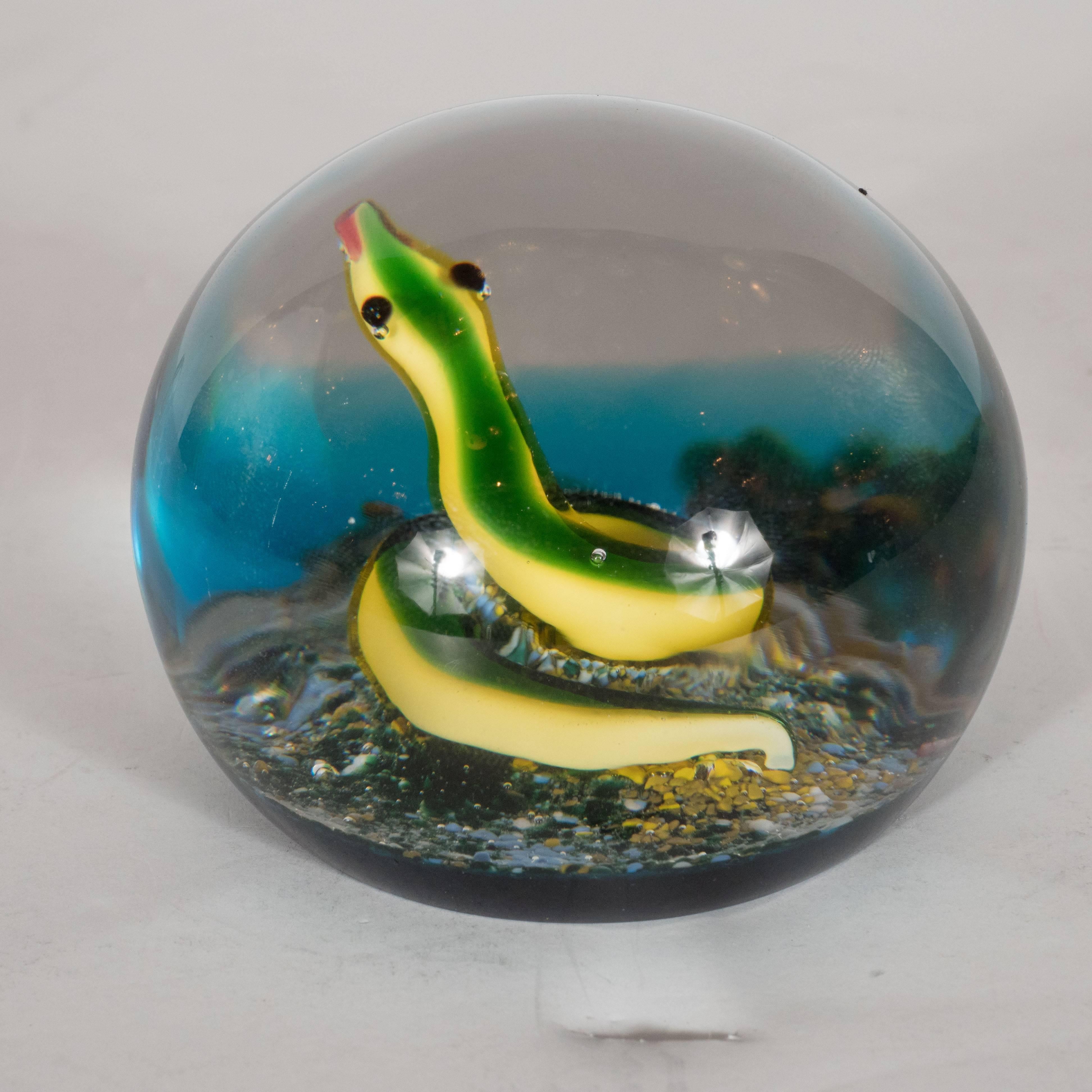 This rare and sought after limited edition Mid-Century Modernist Baccarat art glass paperweight was produced by the illustrious French glass maker, circa 1971. Handblown in hues of emerald, robin's egg blue, aquamarine, and canary yellow, this is